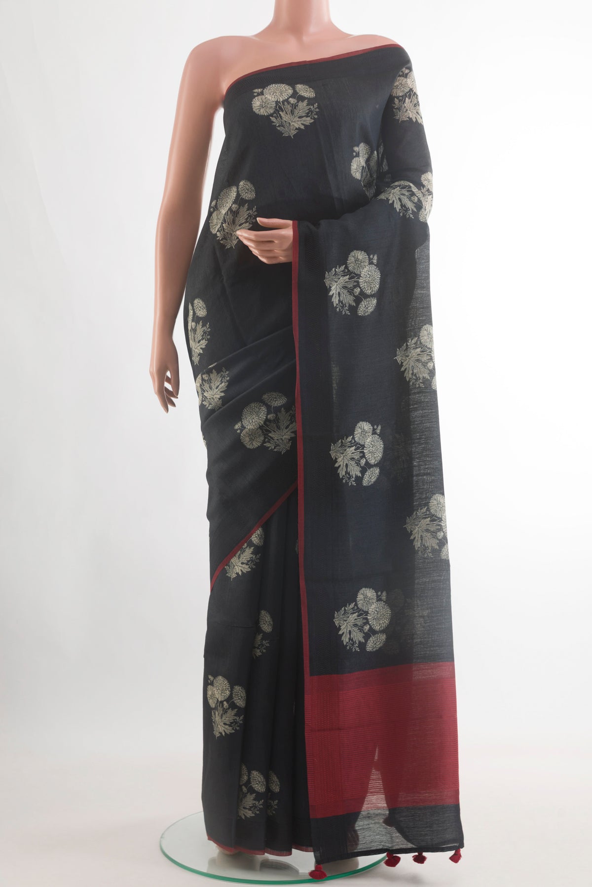 Black Tussar Silk Saree with Printed design on the body and Without Border.  displayed on a mannequin