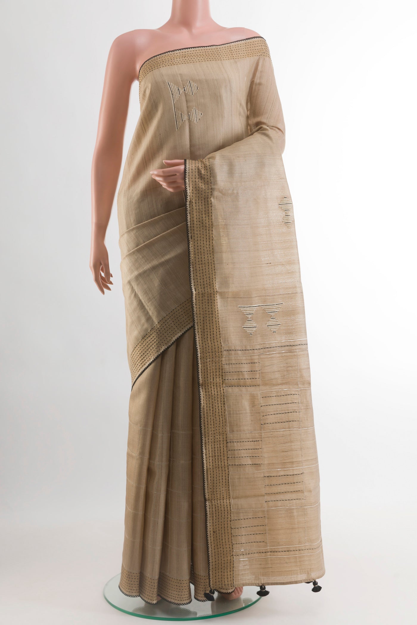 Beige Tussar Silk Saree with Embroidery on the body and Embroidery Border.  displayed on a mannequin