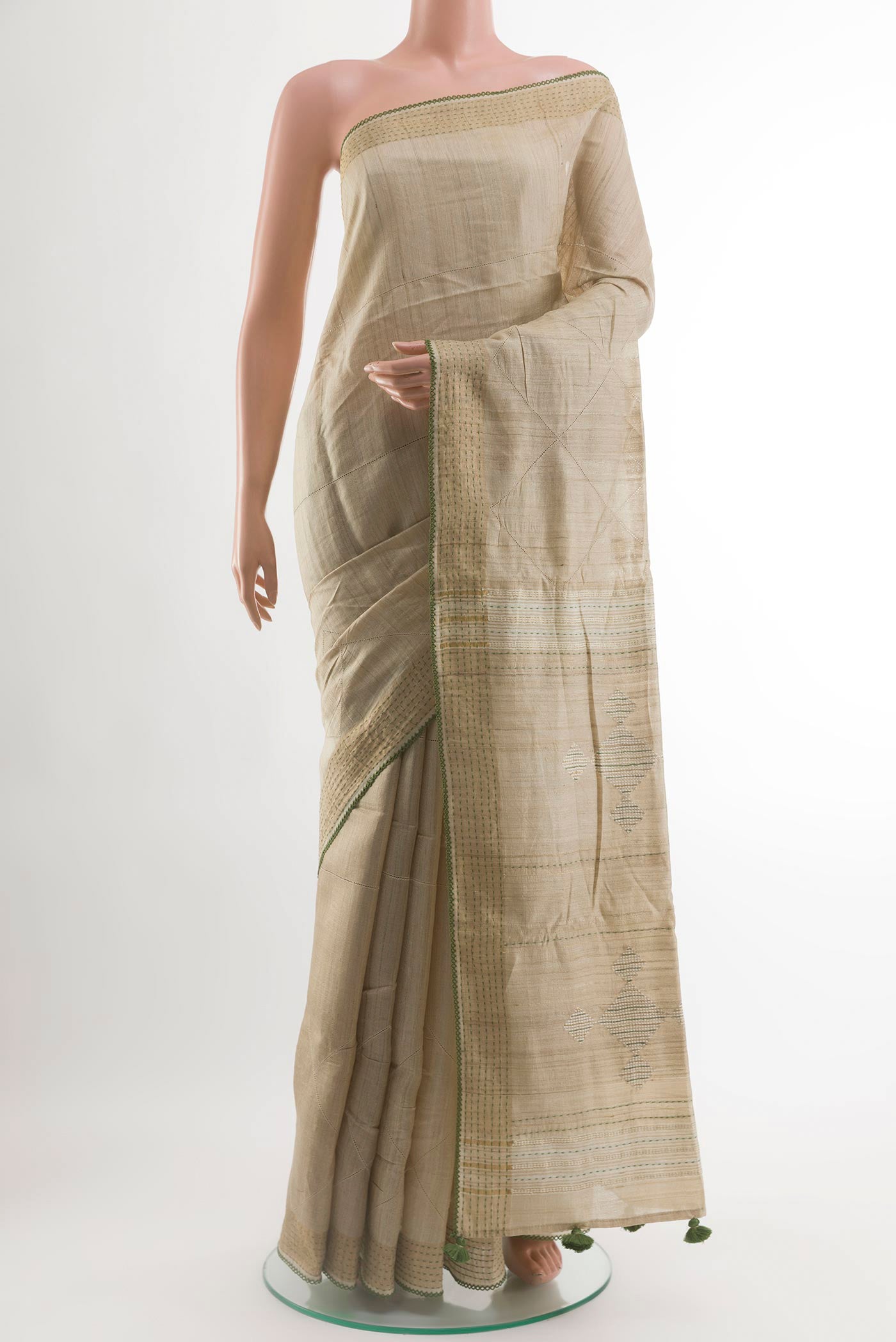 Beige Tussar Silk Saree with Embroidery on the body and Embroidery Border.  displayed on a mannequin