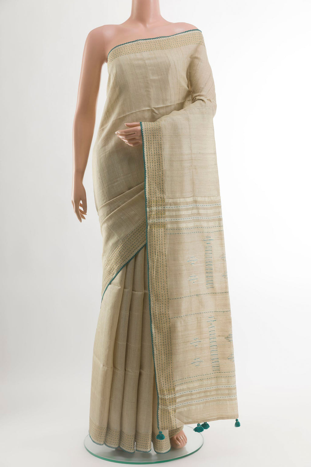 Beige Tussar Silk Saree with Embroidery on the body and Embroidery Border.  displayed on a mannequin
