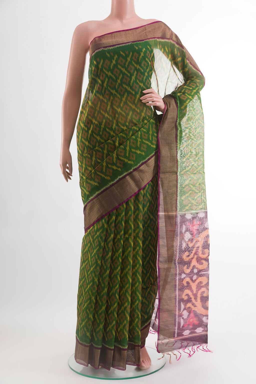 Green Silk Cotton Saree with Ikat design on the body and Zari Border.  displayed on a mannequin