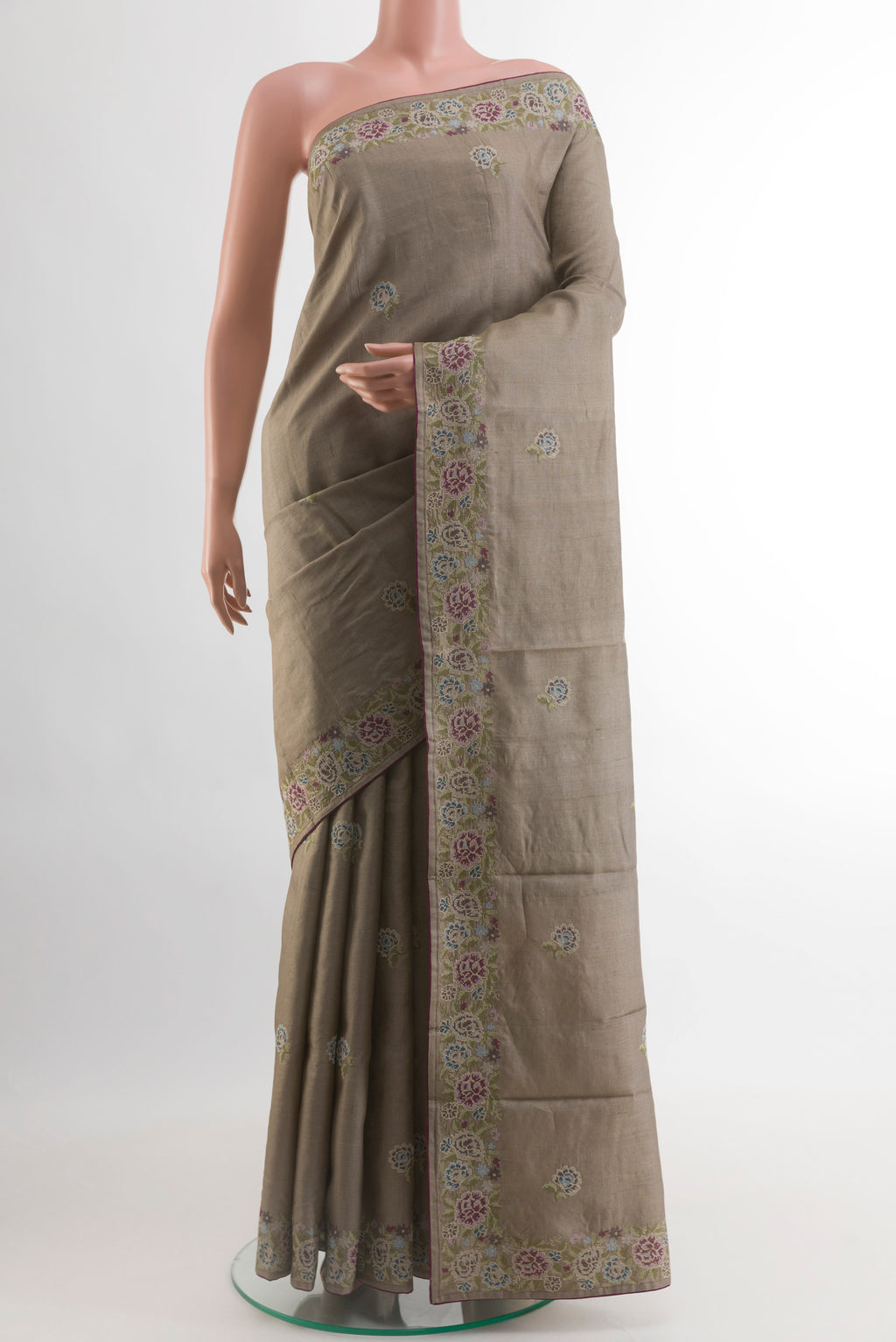 Grey Tussar Silk Saree with Embroidery on the body and Embroidery Border.  displayed on a mannequin