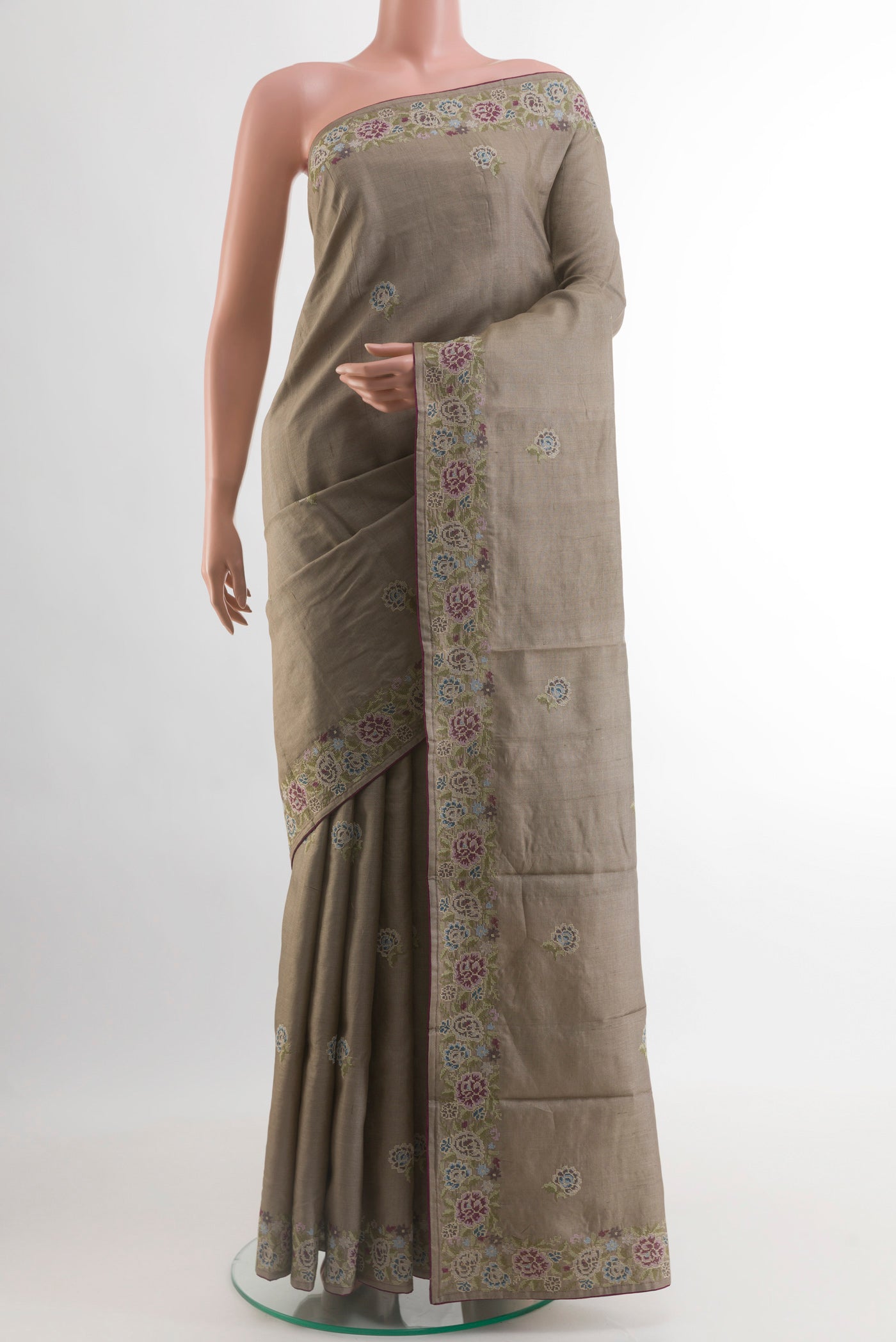 Grey Tussar Silk Saree with Embroidery on the body and Embroidery Border.  displayed on a mannequin