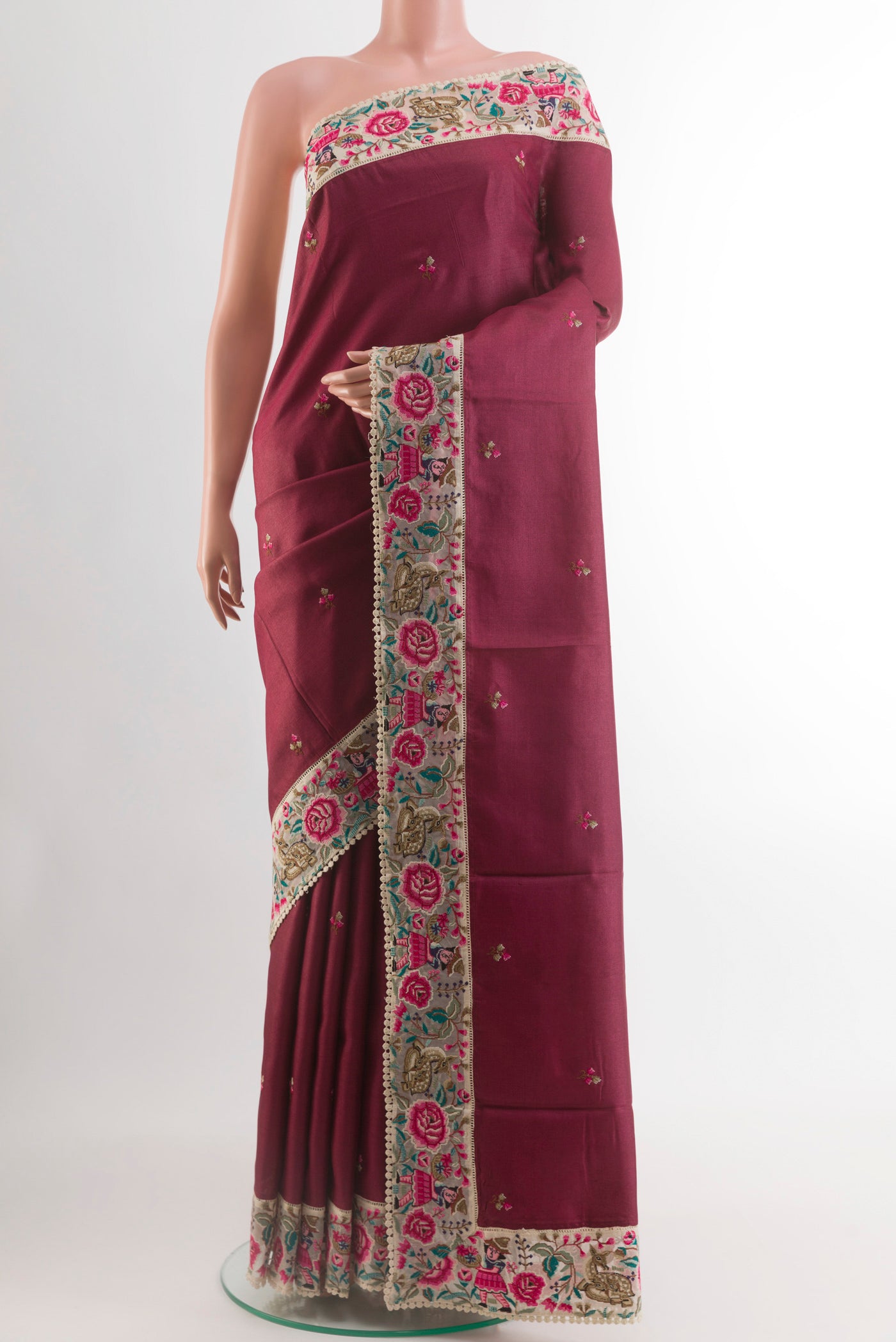 Maroon Tussar Silk Saree with Embroidery on the body and Embroidery Border.  displayed on a mannequin