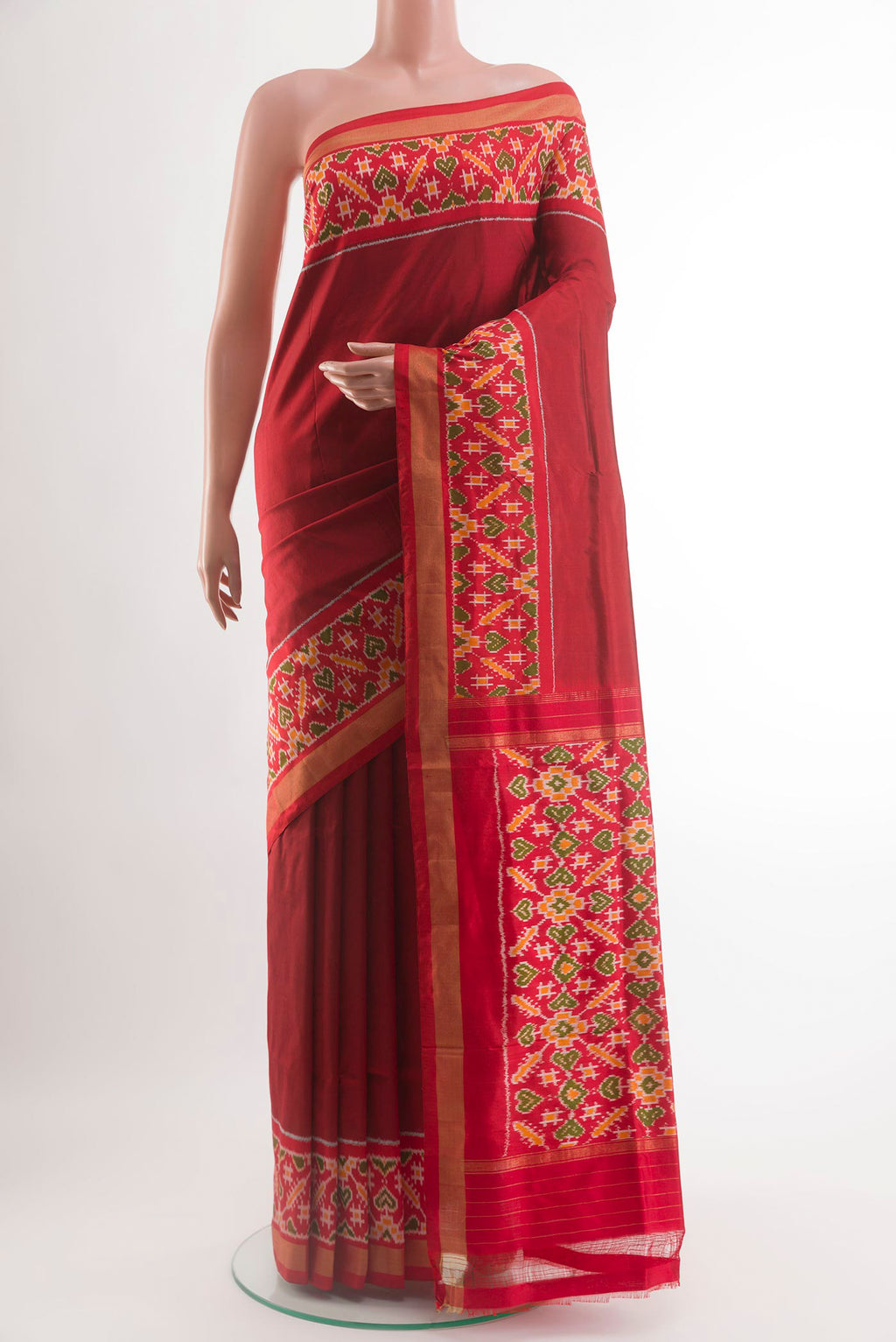 Red Pochampally Silk Saree with Plain Body and Ikat Border.  displayed on a mannequin