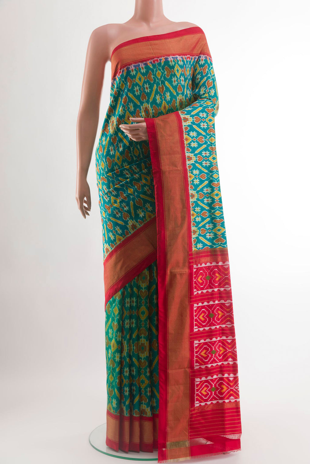 Green Pochampally Silk Saree with Pure Ikat on the body and Zari Border.  displayed on a mannequin