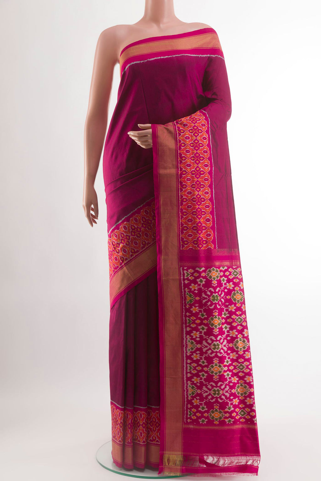 Magenta Pochampally Silk Saree with Plain Body and Ikat Border.  displayed on a mannequin
