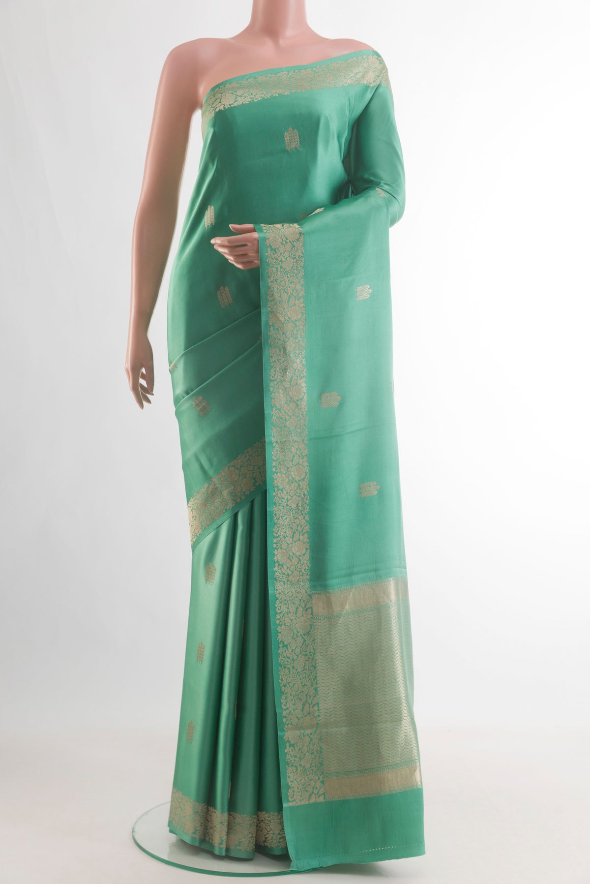 Sea Green Banarasi Silk Saree with Zari Butta on the body and Zari Border.  displayed on a mannequin