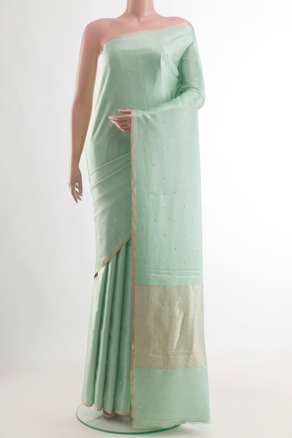 Mint Green Banarasi Silk Saree with Zari Butta on the body and Zari Border.  displayed on a mannequin