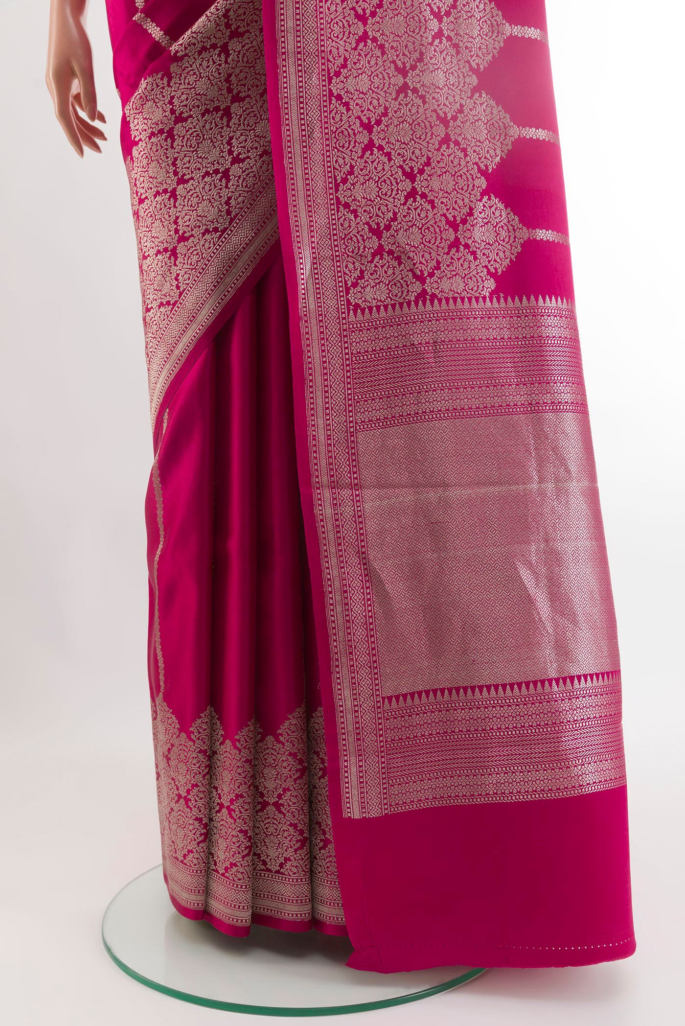 Pleats and pallu of Rani Pink Banarasi Silk Saree with Stripes on the body and Zari Border. 