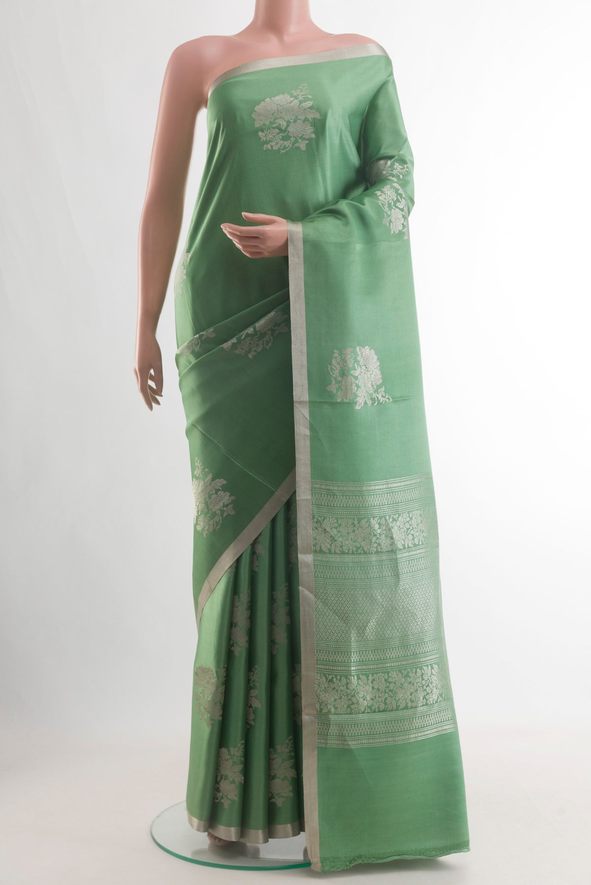 Green Banarasi Silk Saree with Zari Butta on the body and Zari Border.  displayed on a mannequin