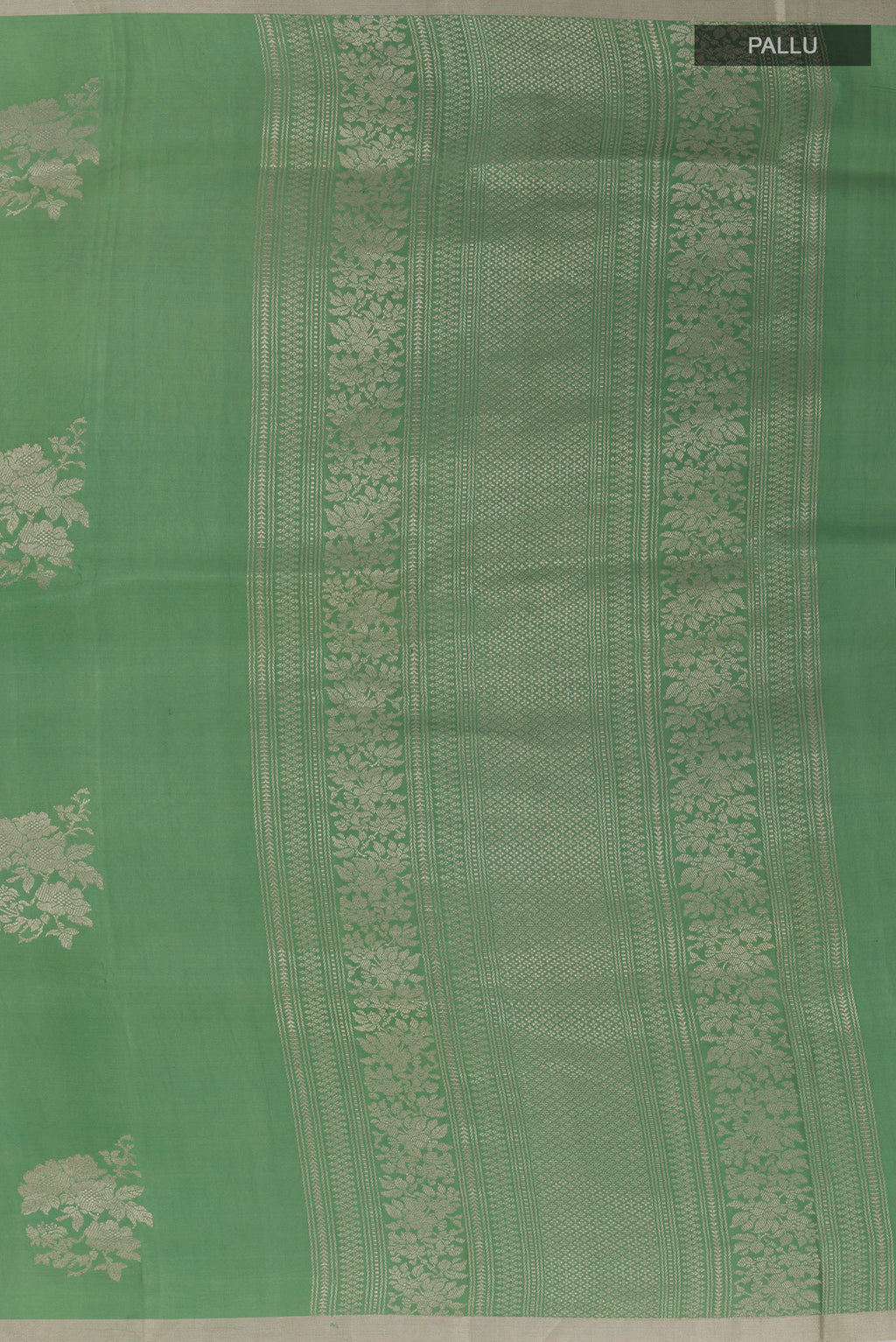 Close up image of the pallu of Green Banarasi Silk Saree with Zari Butta on the body and Zari Border. 