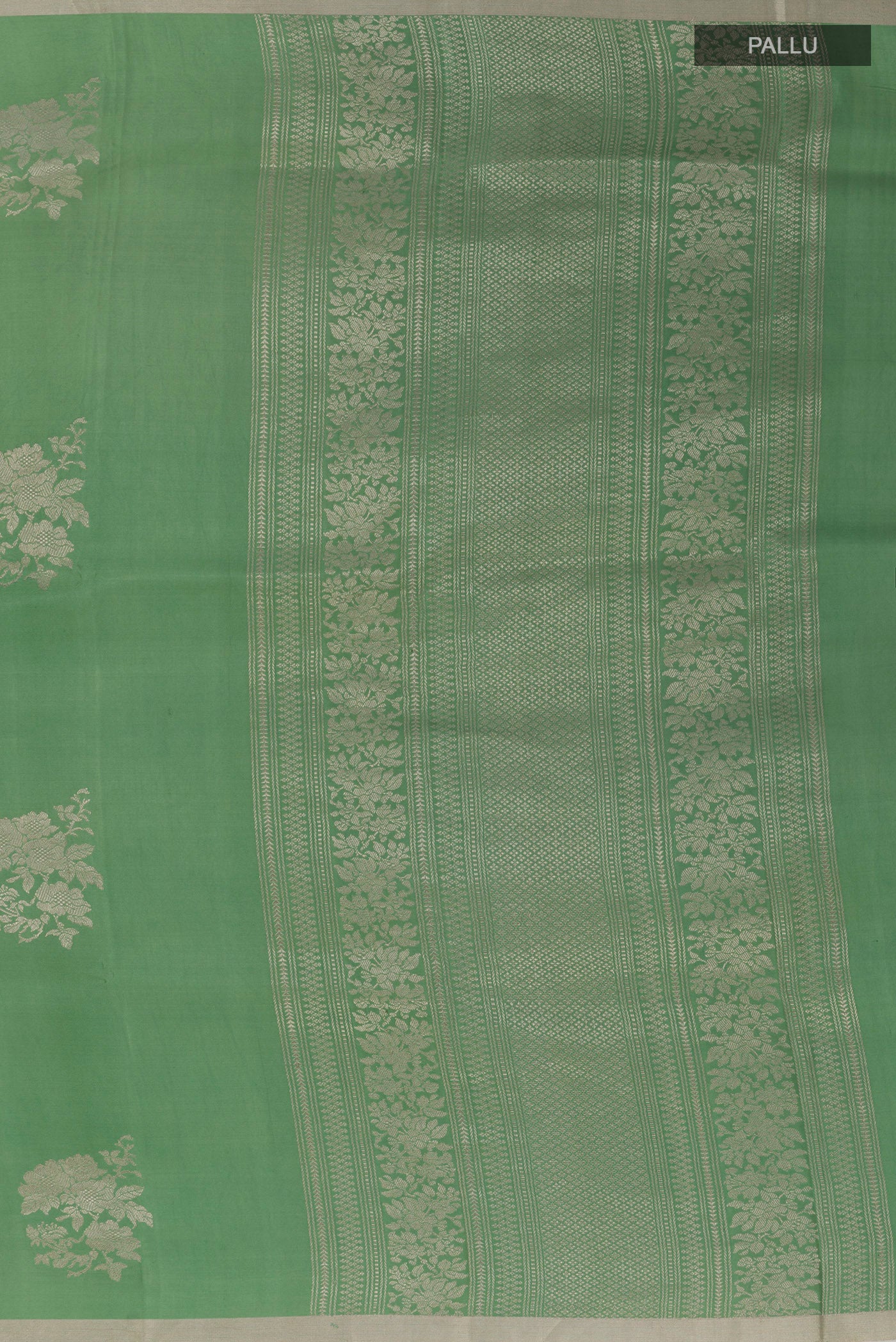 Close up image of the pallu of Green Banarasi Silk Saree with Zari Butta on the body and Zari Border. 