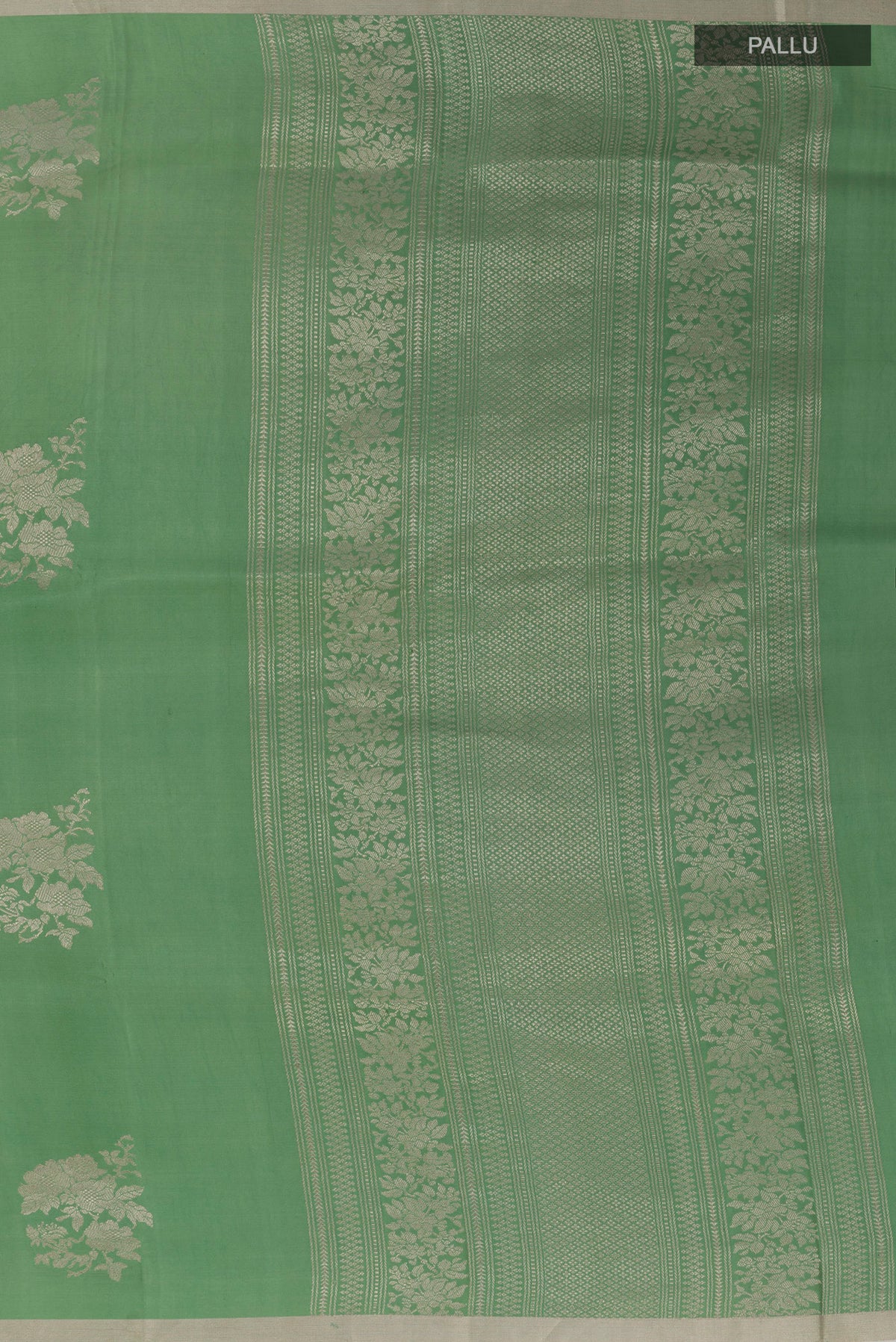 Close up image of the pallu of Green Banarasi Silk Saree with Zari Butta on the body and Zari Border. 