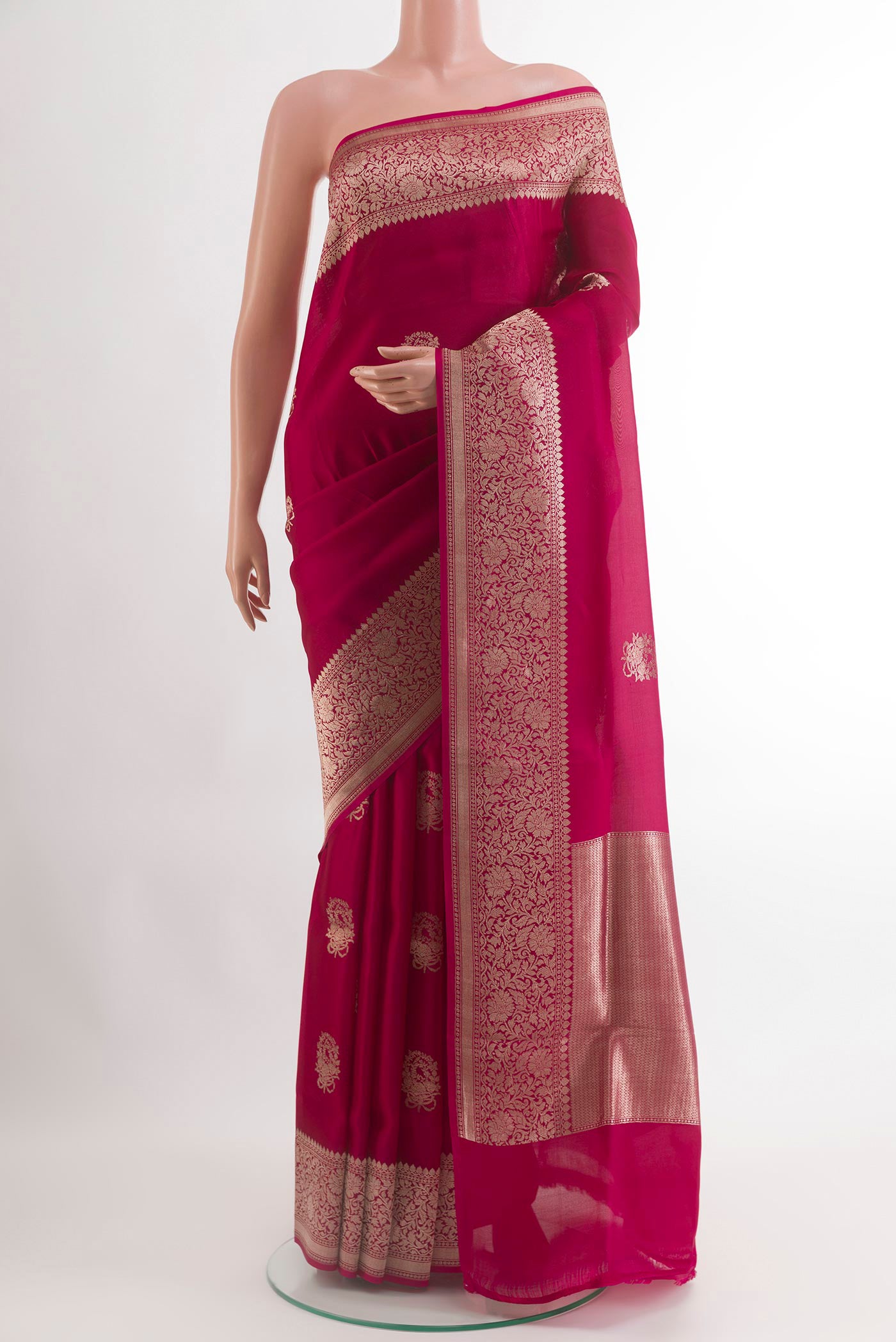 Maroon Banarasi Kora Silk Saree with Zari Butta on the body and Zari Border.  displayed on a mannequin