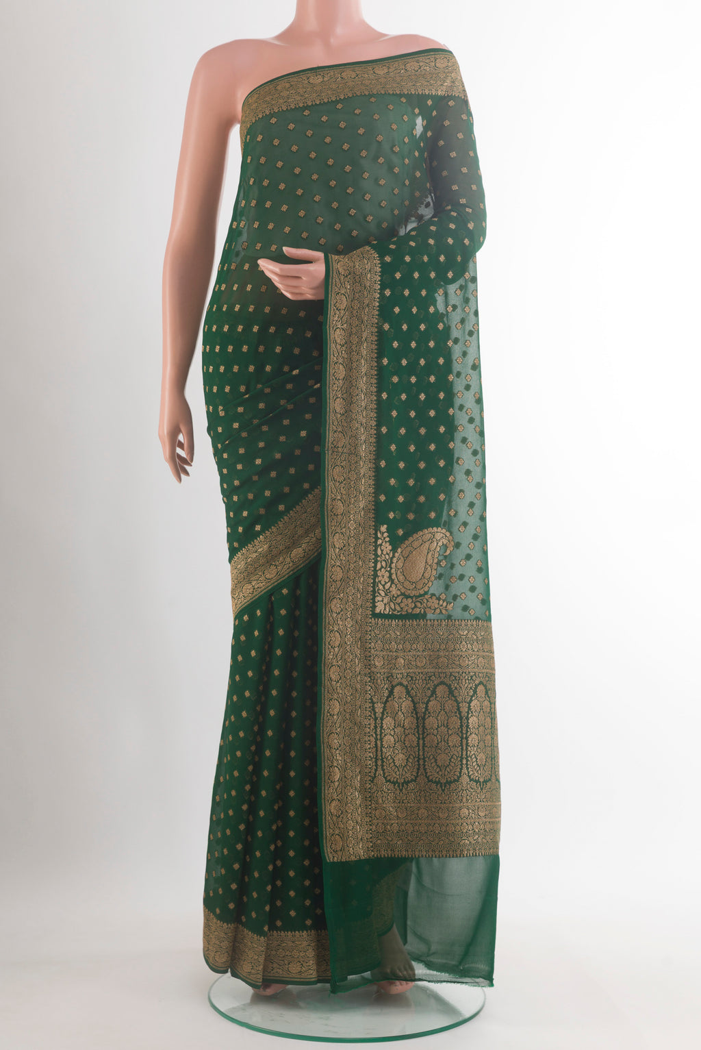 Bottle Green Banarasi Georgette Saree with Zari Butta on the body and Zari Border.  displayed on a mannequin