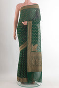 Bottle Green Banarasi Georgette Saree with Zari Butta on the body and Zari Border.  displayed on a mannequin