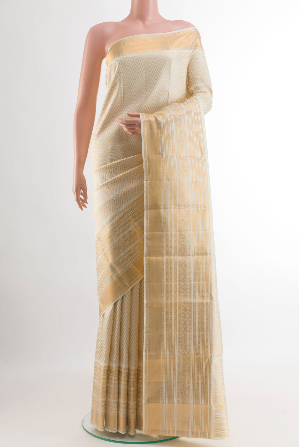 Off White Kanchipuram Silk Saree with Zari Brocade on the body and Zari Border.  displayed on a mannequin
