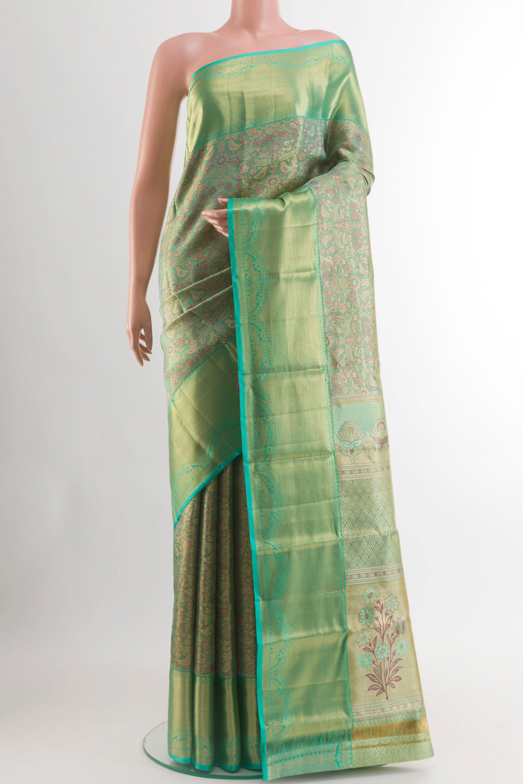 Green Kanjivaram Tissue Silk Saree with Zari Brocade on the body and Zari Border.  displayed on a mannequin