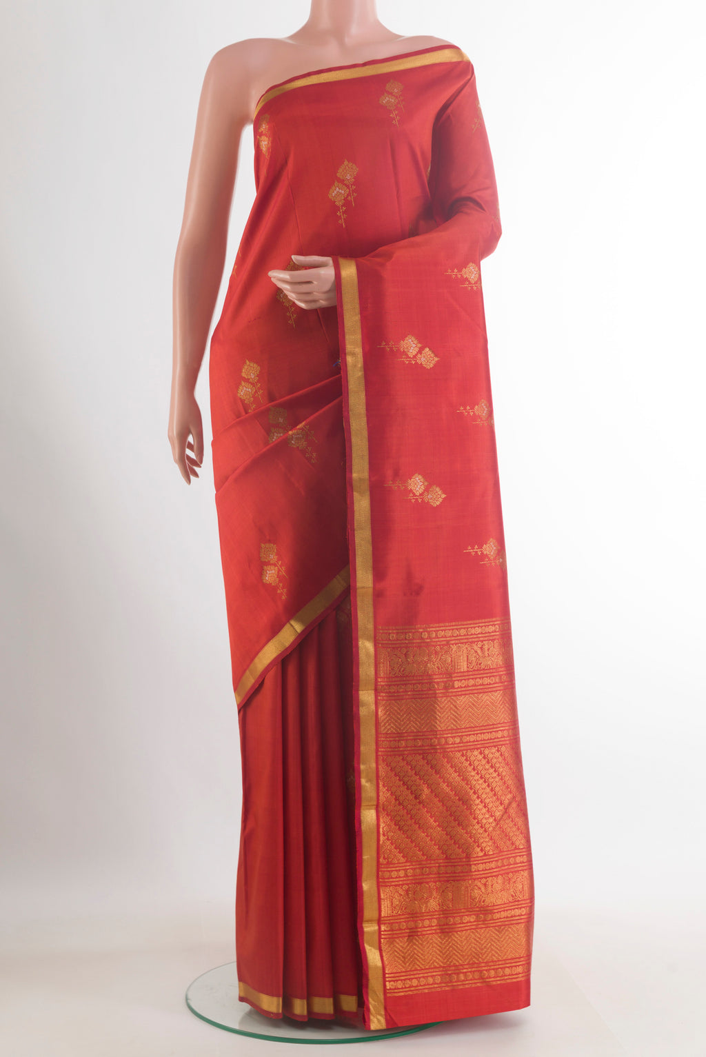 Pure Silk Red Kanjivaram Saree with Zari Butta on the body and Zari Border.  displayed on a mannequin