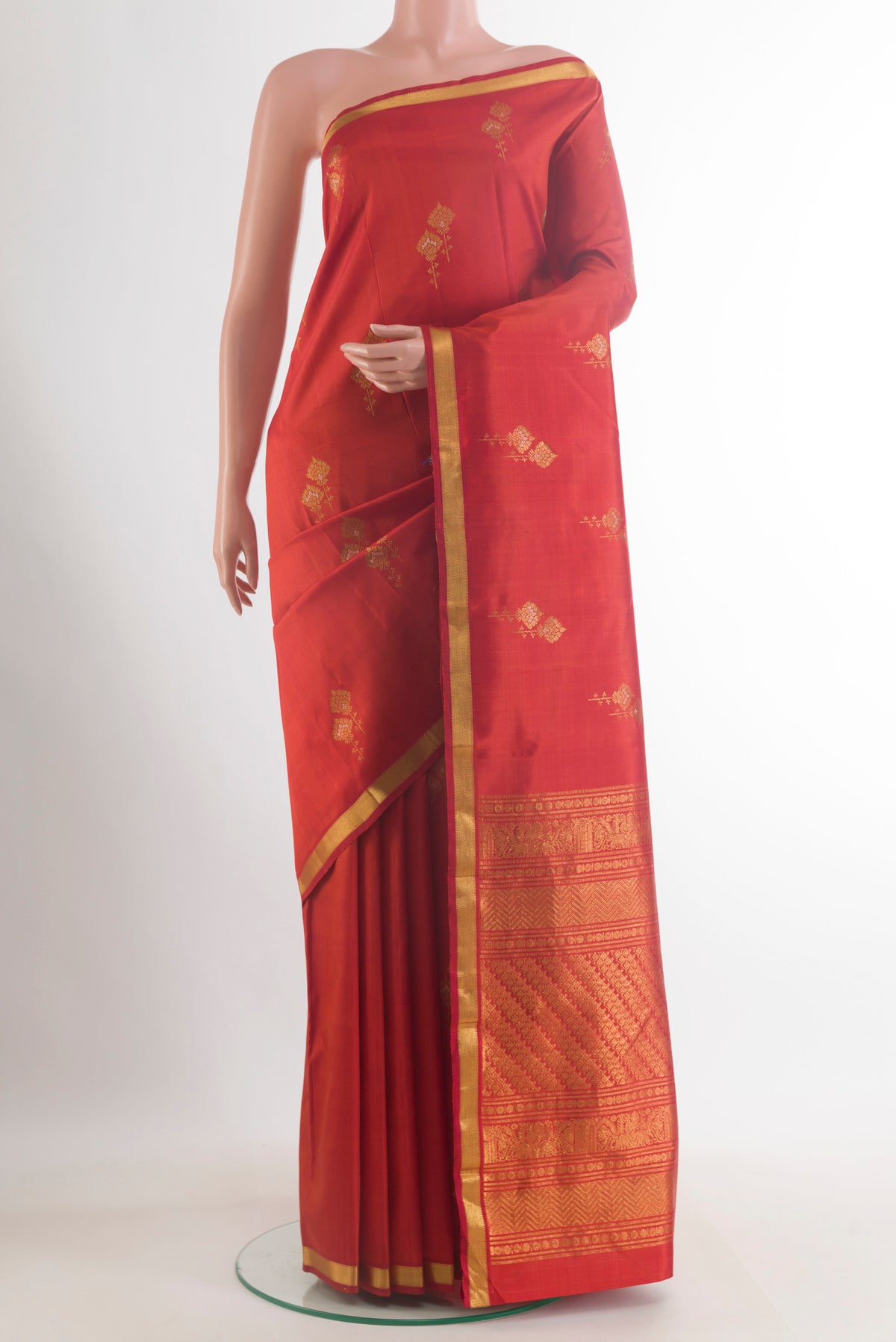 Pure Silk Red Kanjivaram Saree with Zari Butta on the body and Zari Border.  displayed on a mannequin