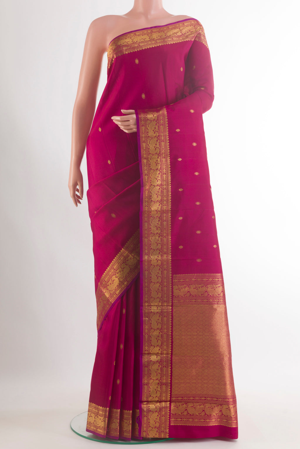 Pure Silk Maroon Kanjivaram Saree with Zari Butta on the body and Zari Border.  displayed on a mannequin