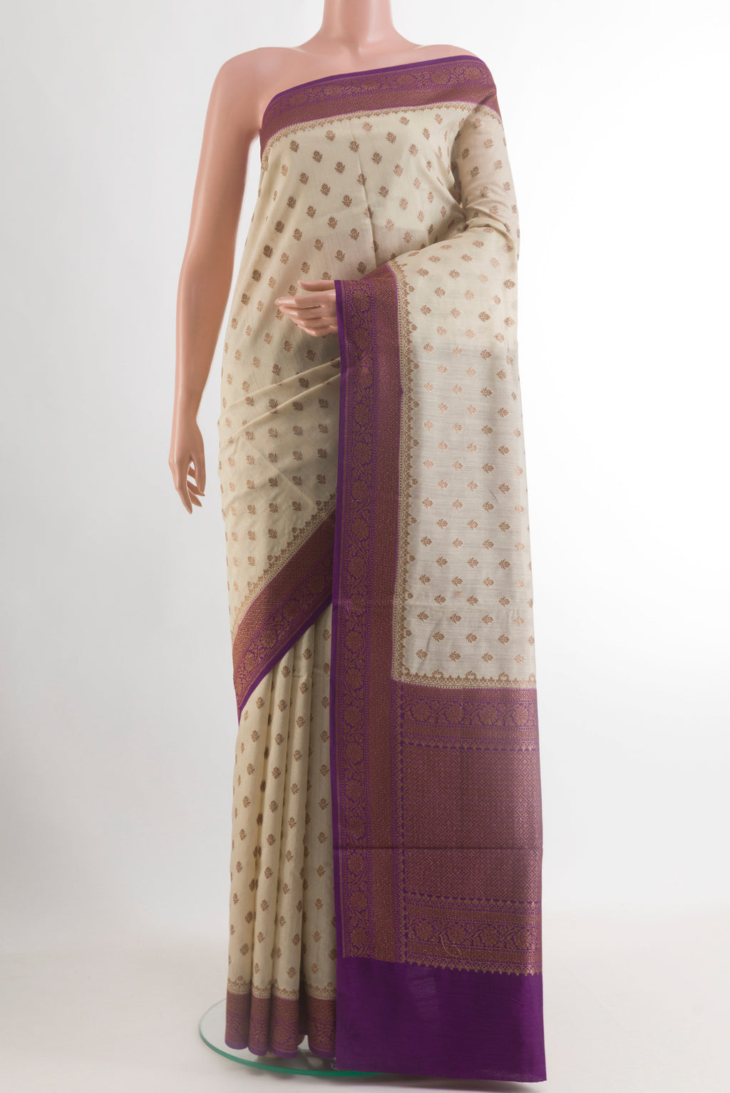Off White Tussar Silk Saree with Zari Butta on the body and Zari Border.  displayed on a mannequin