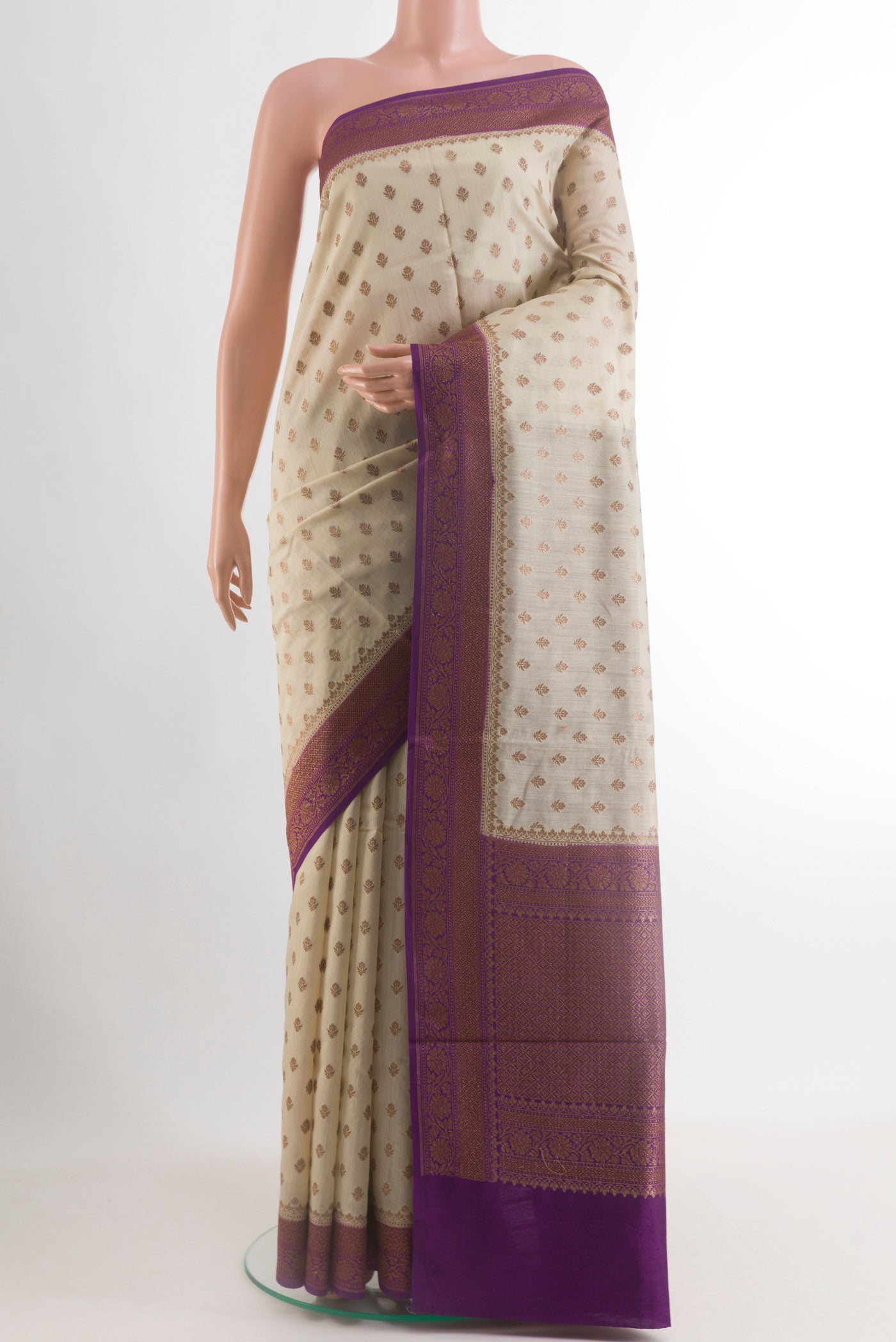 Off White Tussar Silk Saree with Zari Butta on the body and Zari Border.  displayed on a mannequin