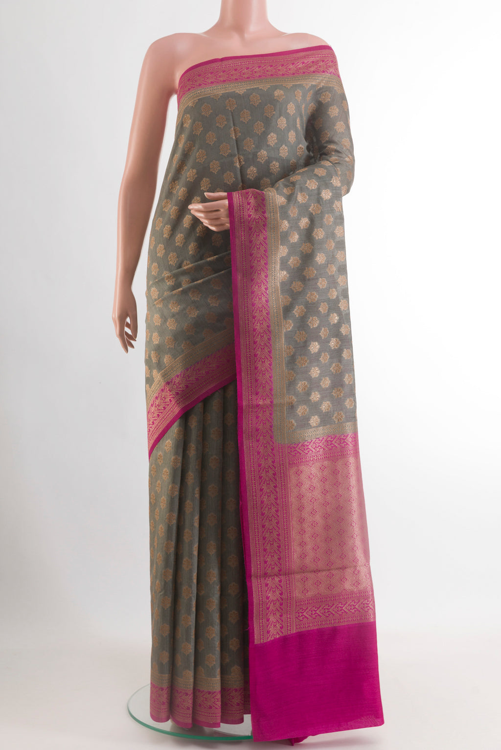 Grey Tussar Silk Saree with Zari Butta on the body and Zari Border.  displayed on a mannequin
