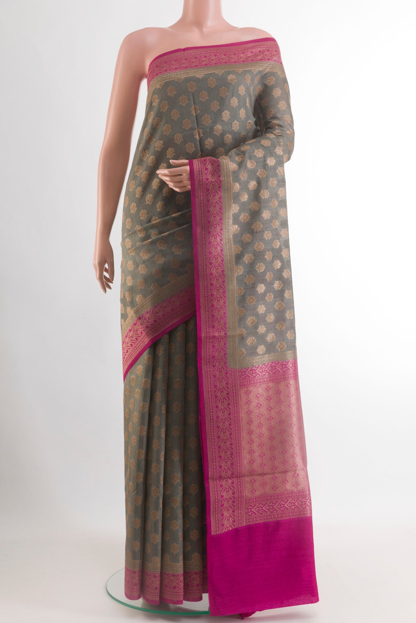 Grey Tussar Silk Saree with Zari Butta on the body and Zari Border.  displayed on a mannequin