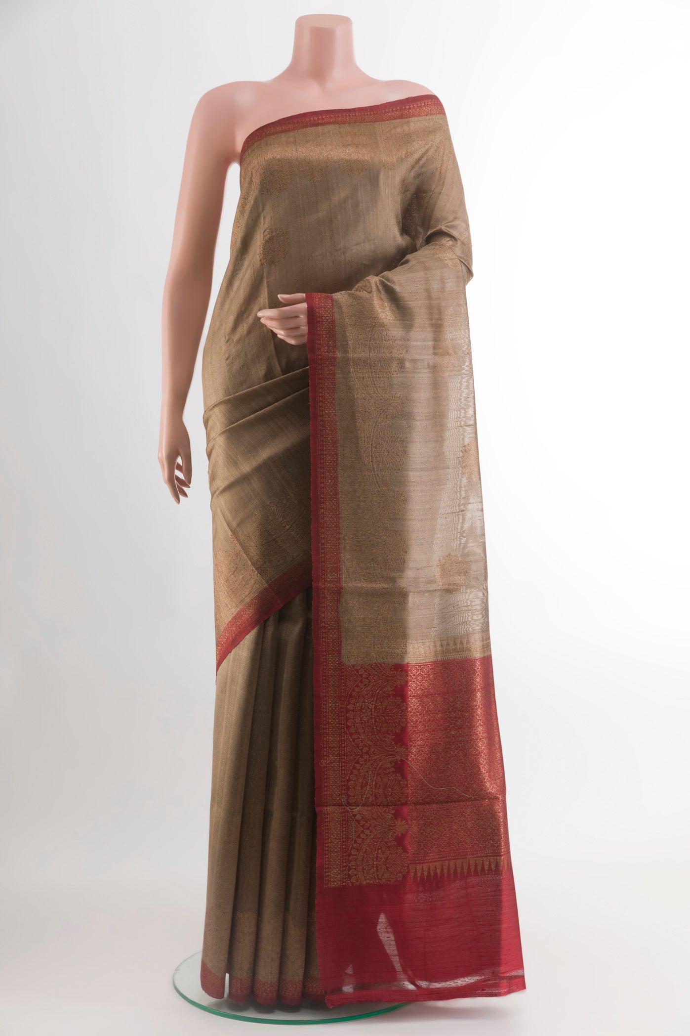 Brown Banarasi Tussar Silk Saree with Zari Butta on the body and Zari Border.  displayed on a mannequin