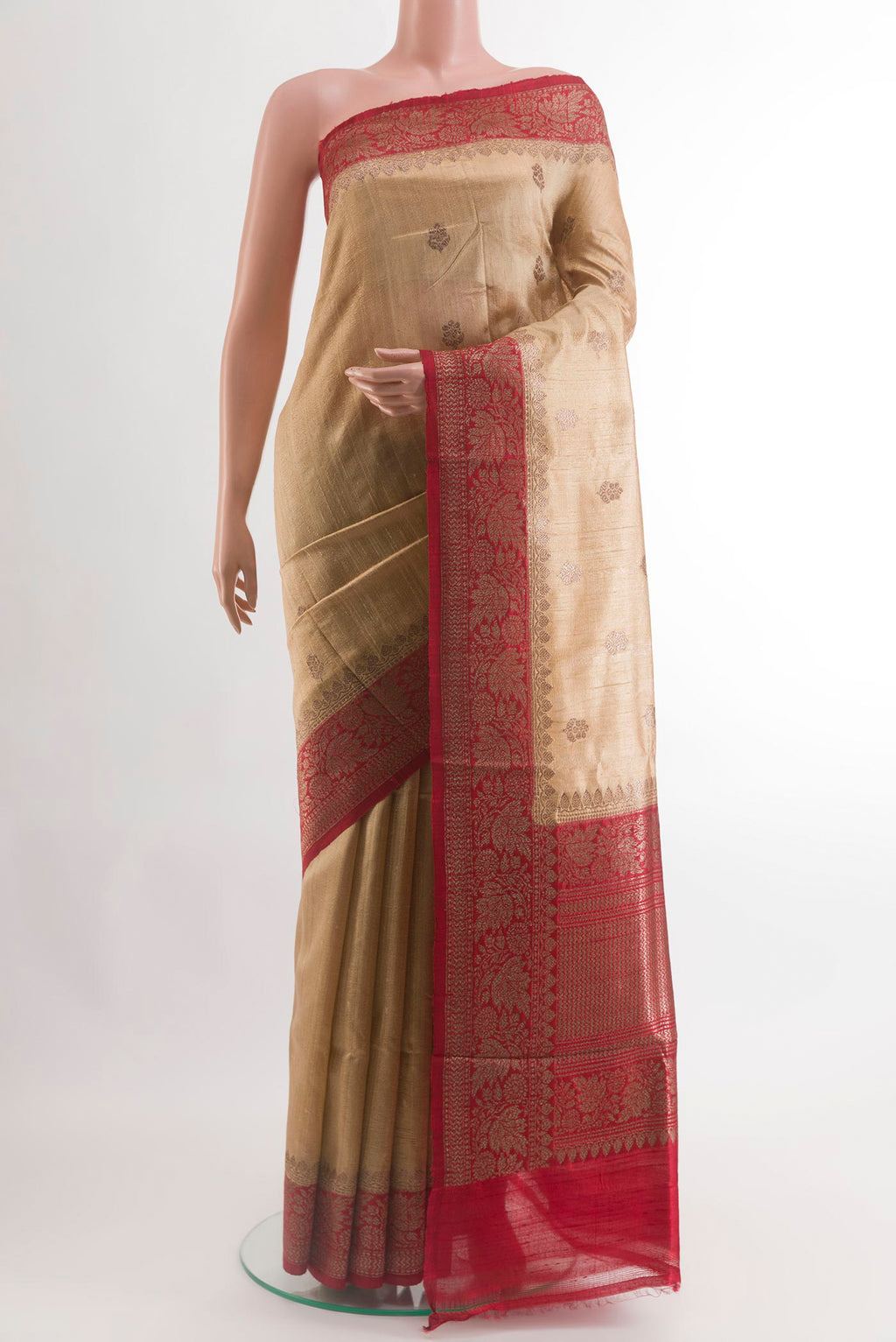 Beige Banarasi Tussar Silk Saree with Zari Butta on the body and Zari Border.  displayed on a mannequin