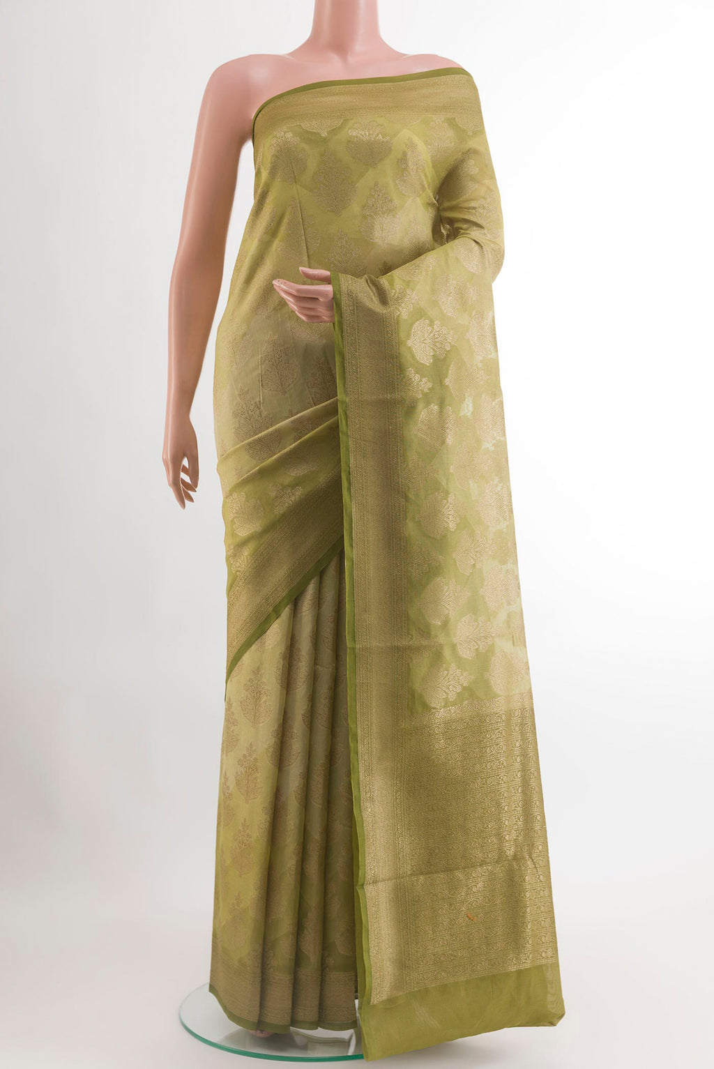 Green Blended Kora Cotton Saree with Zari Butta on the body and Zari Border.  displayed on a mannequin