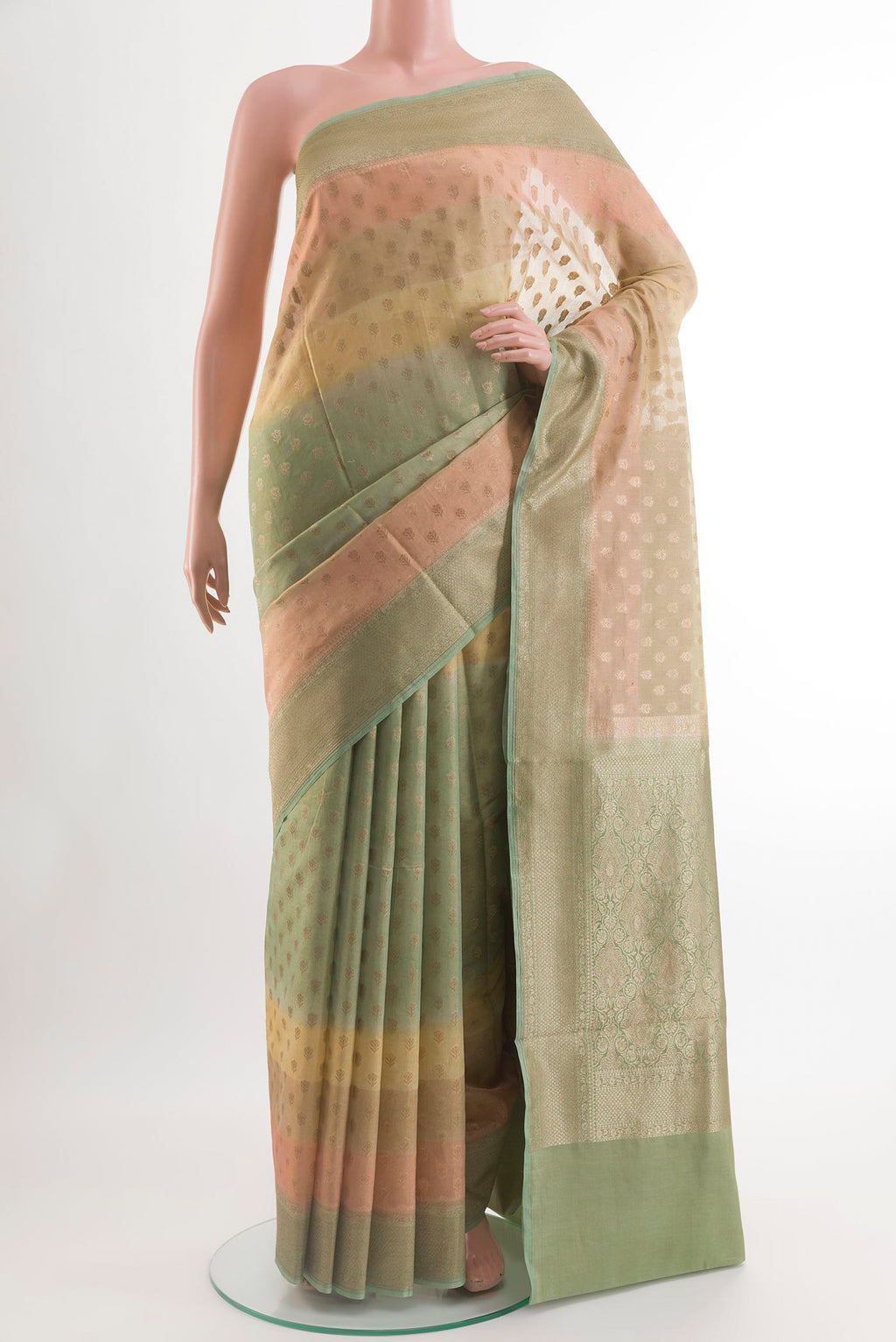 Green Blended Kora Cotton Saree with Zari Butta on the body and Zari Border.  displayed on a mannequin