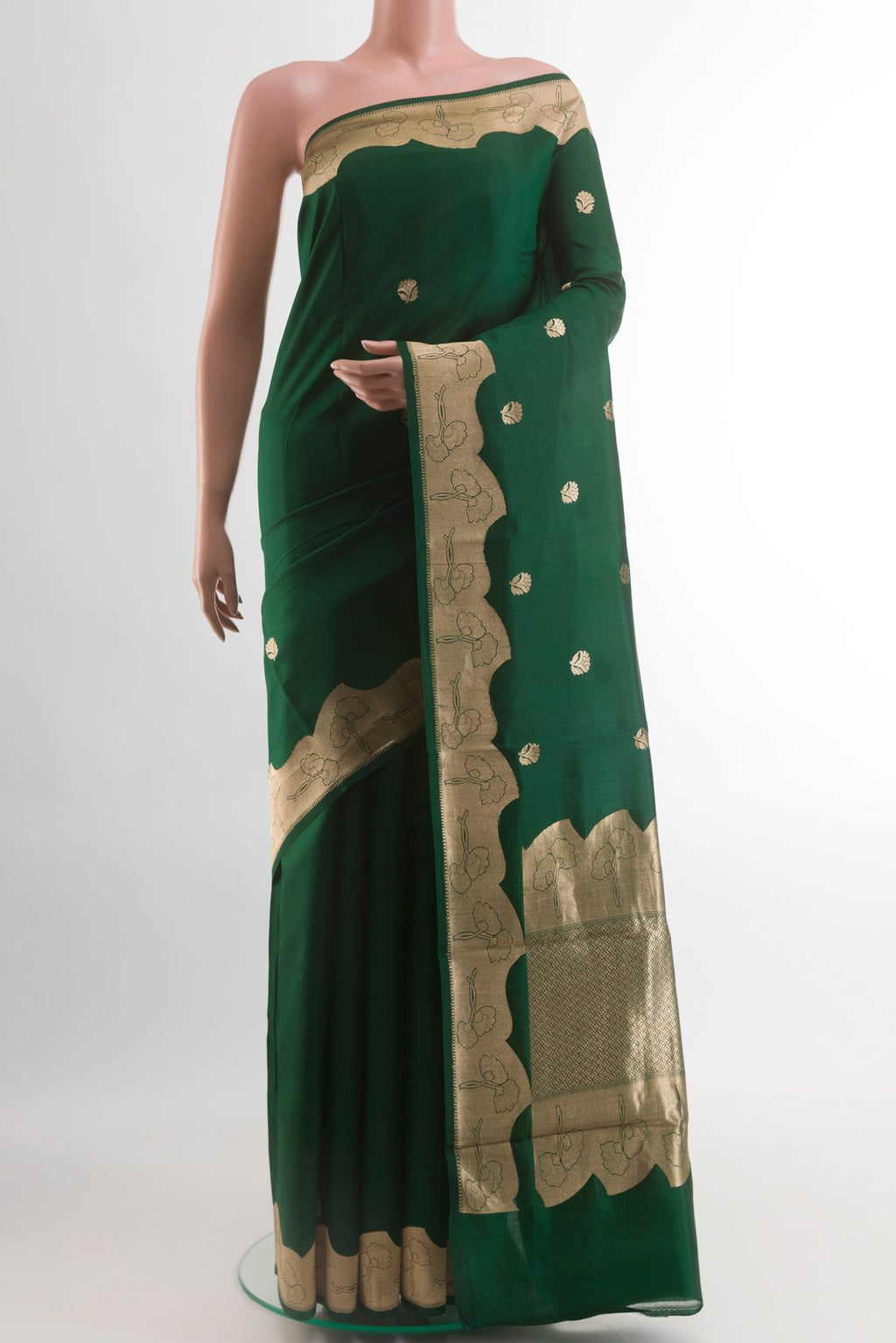 Bottle Green Banarasi Katan Silk Saree with Zari Butta on the body and Zari Border.  displayed on a mannequin