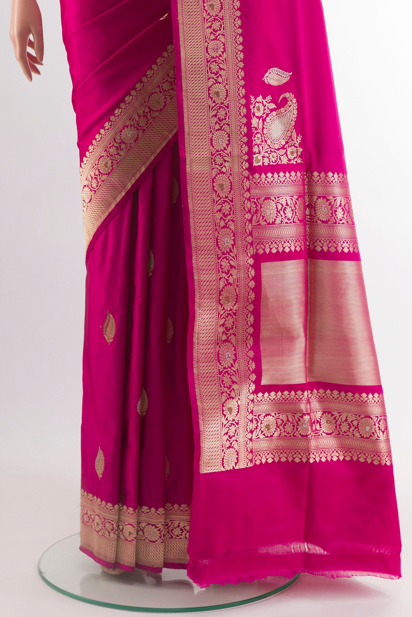 Pleats and pallu of Rani Pink Banarasi Silk Saree with Zari Butta on the body and Zari Border. 