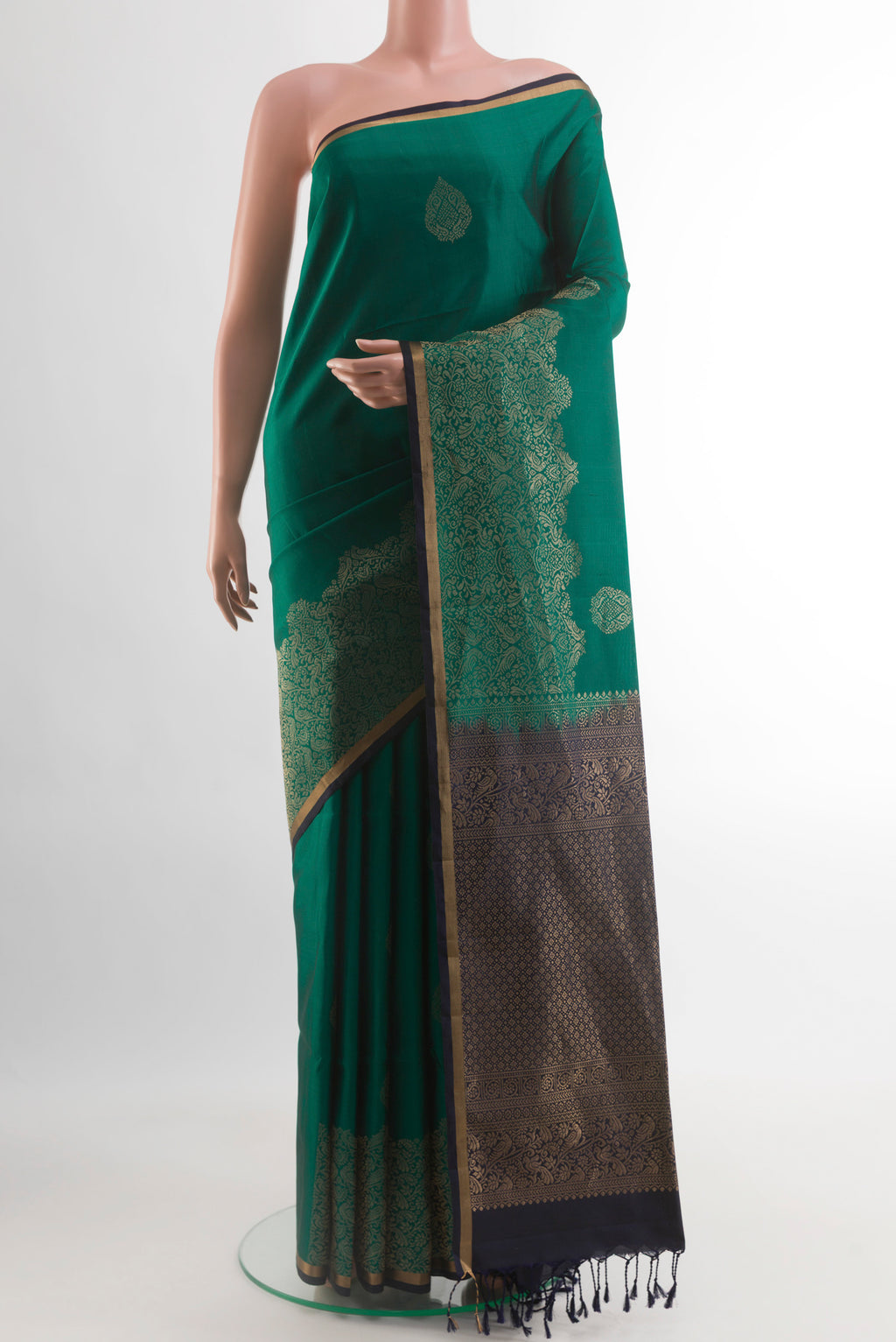Teal Soft Silk Saree with Zari Butta on the body and Zari Border.  displayed on a mannequin