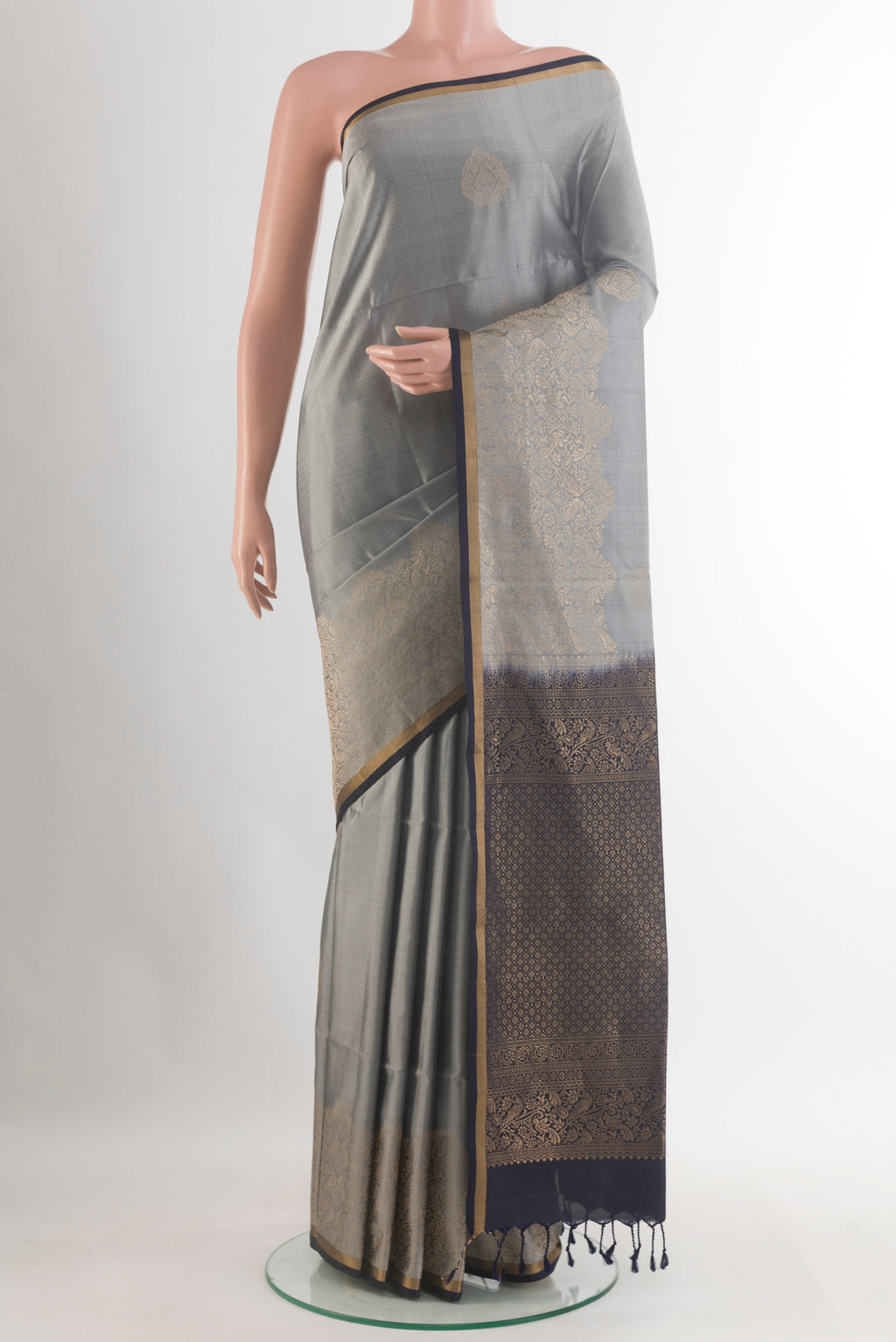 Pure Silk Grey Soft Saree with Zari Butta on the body and Zari Border.  displayed on a mannequin