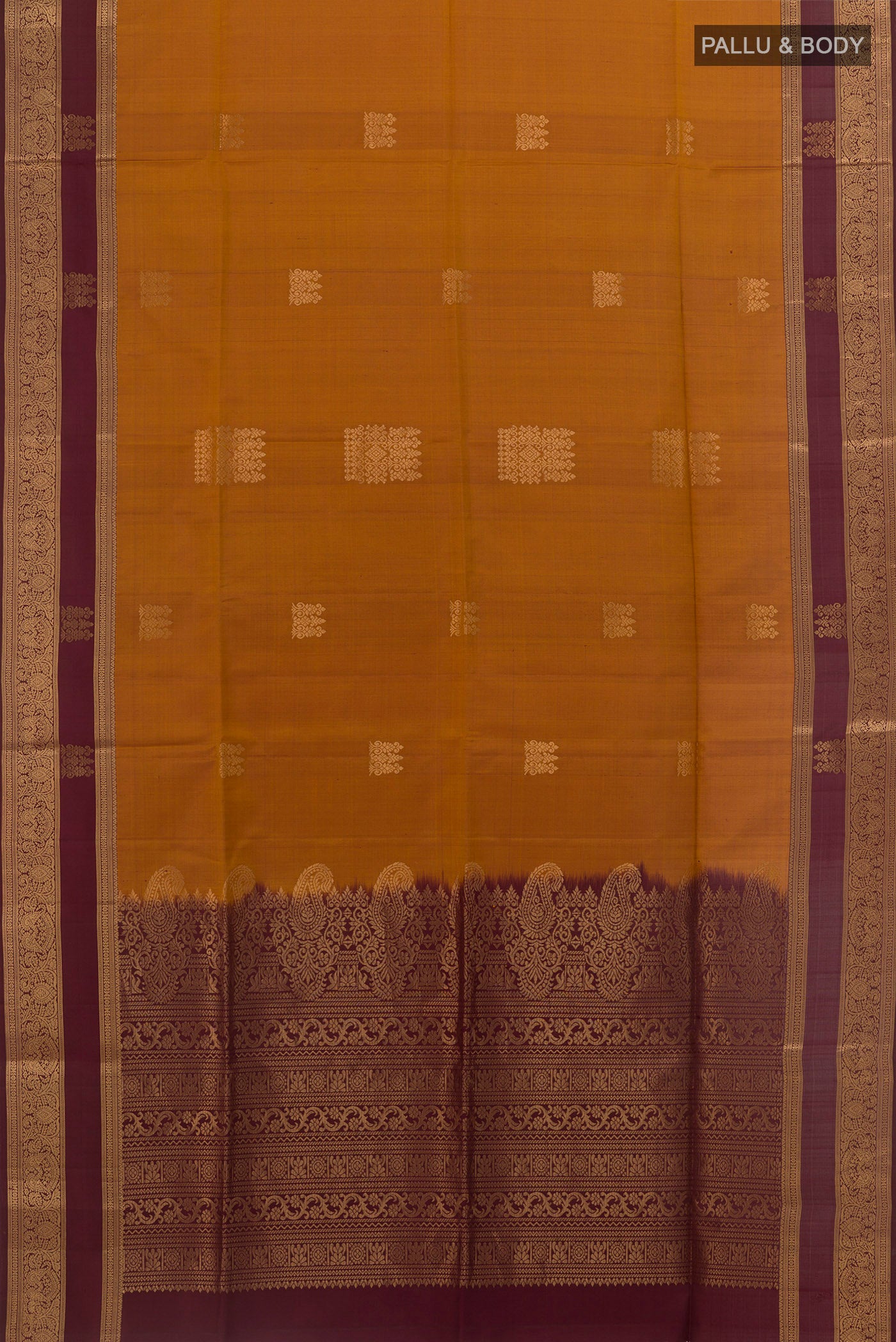 Flat view of Mustard Soft Silk Saree with Zari Butta on the body and Zari Border. 