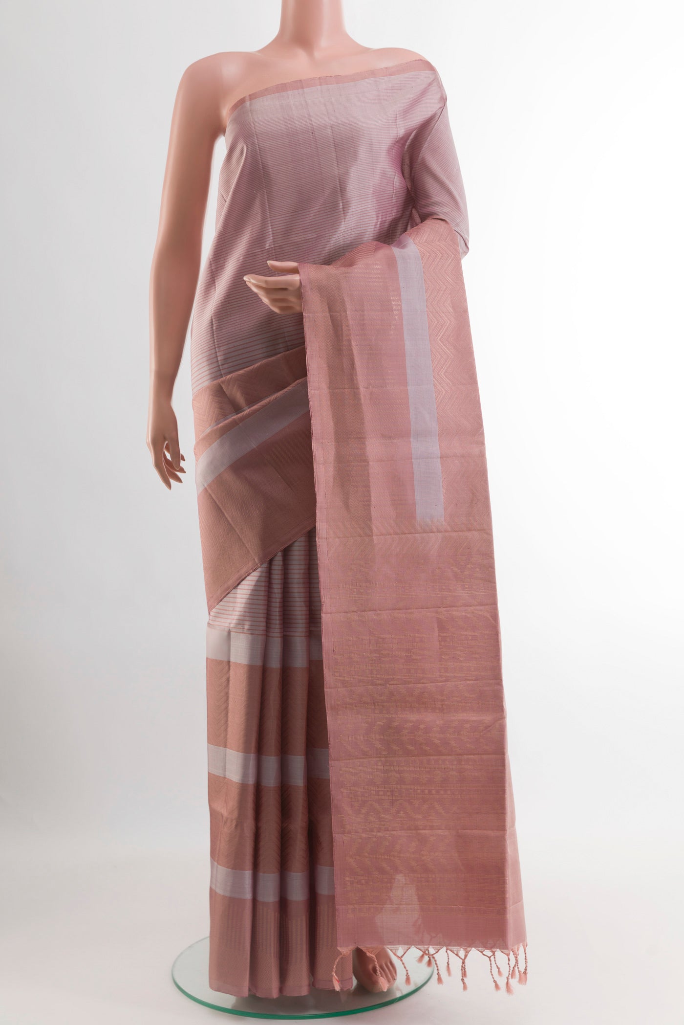 Rose Gold Soft Silk Saree with Stripes on the body and Without Border.  displayed on a mannequin