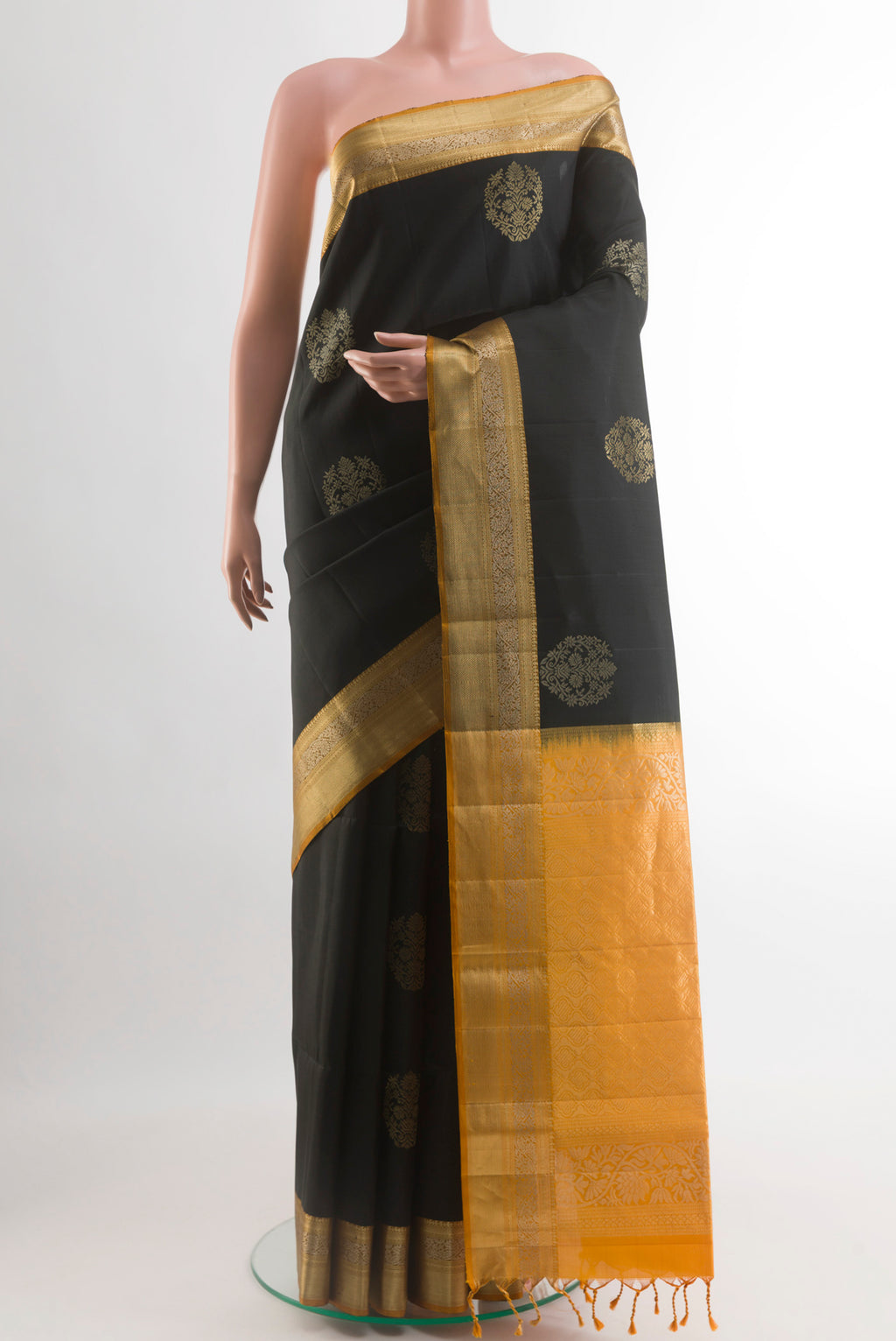 Black Soft Silk Saree with Zari Butta on the body and Zari Border.  displayed on a mannequin