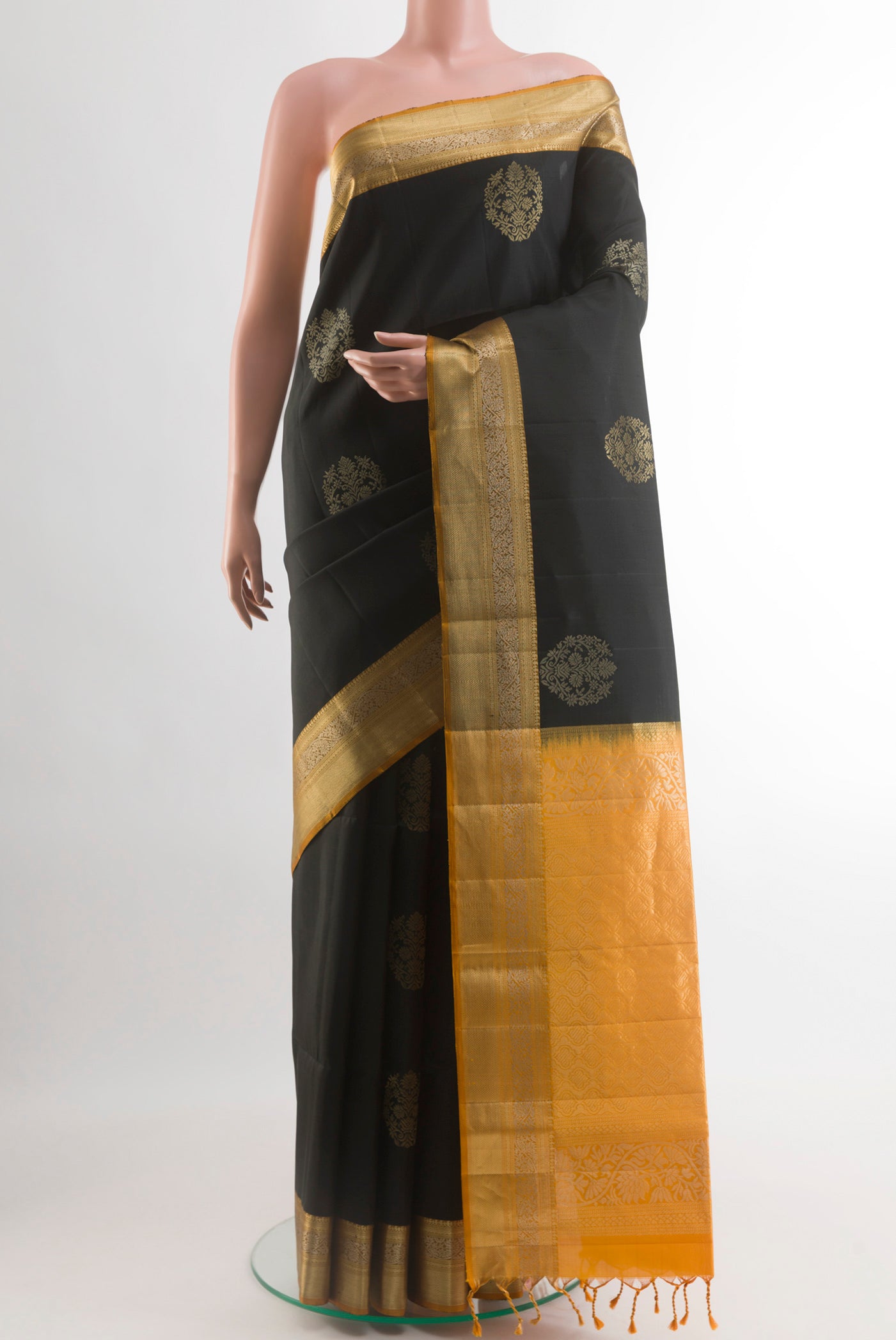 Black Soft Silk Saree with Zari Butta on the body and Zari Border.  displayed on a mannequin
