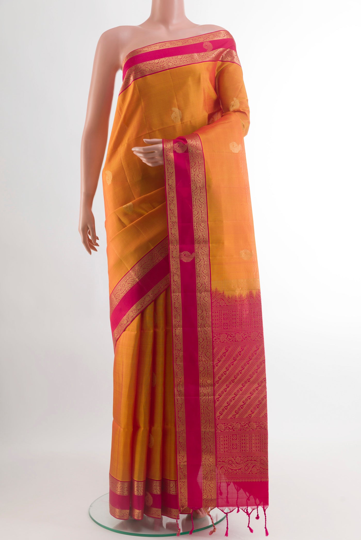 Yellow Soft Silk Saree with Zari Butta on the body and Zari Border.  displayed on a mannequin
