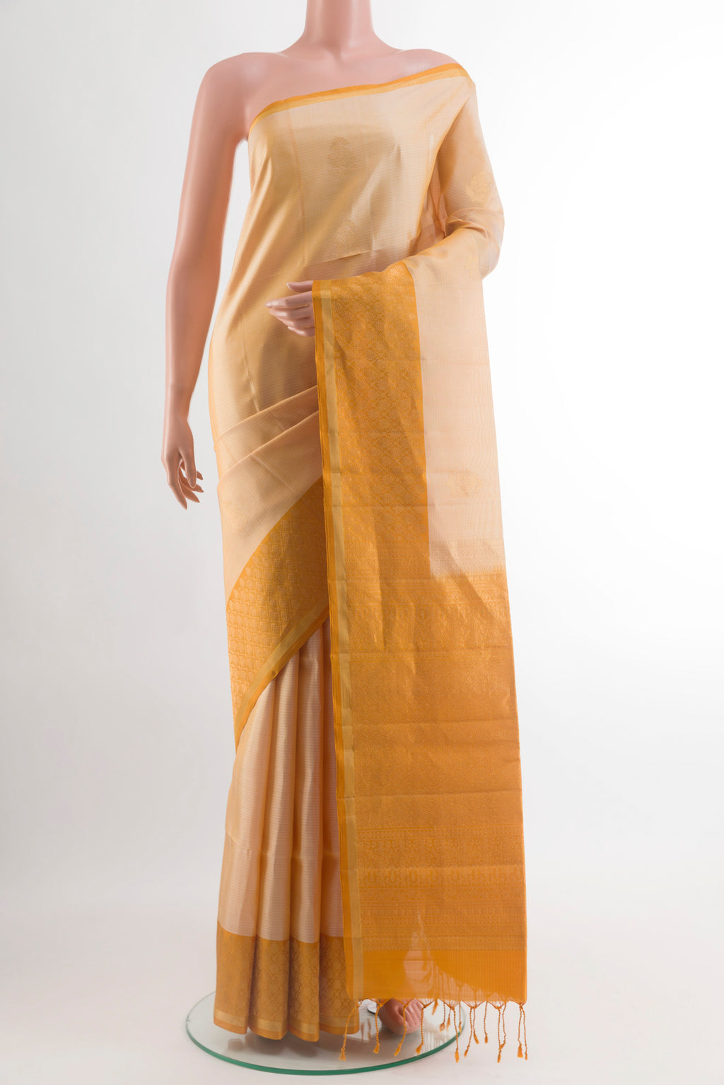 Beige Soft Silk Saree with Zari Butta on the body and Zari Border.  displayed on a mannequin