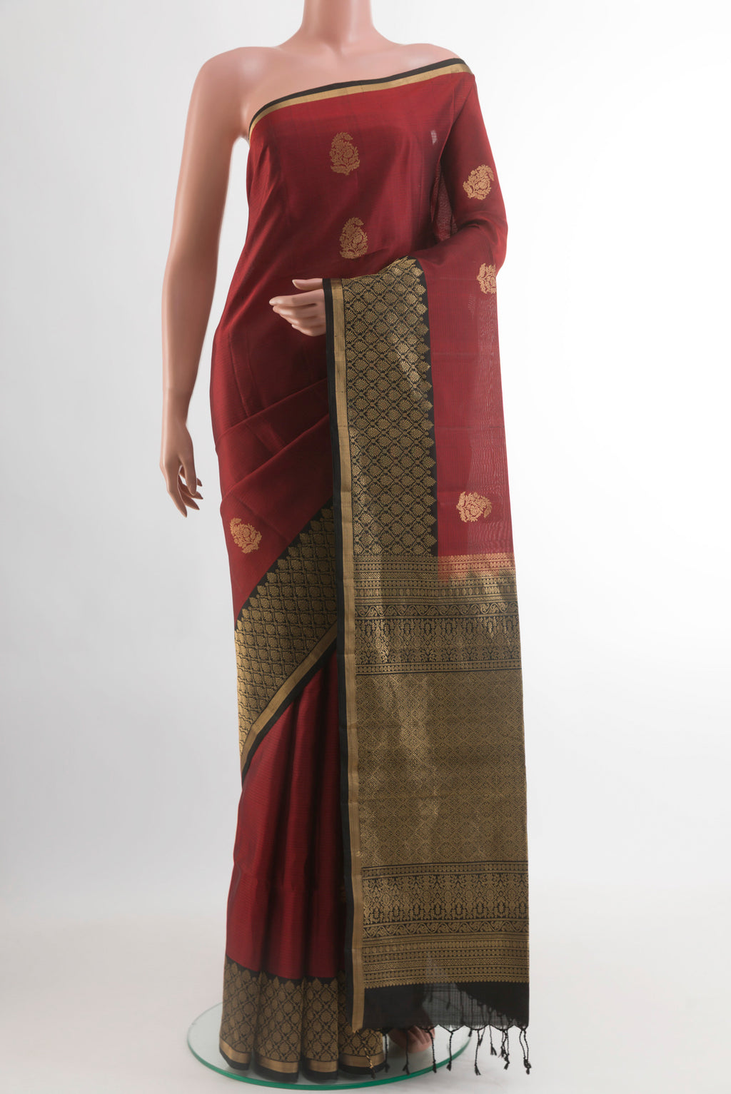 Maroon Soft Silk Saree with Zari Butta on the body and Zari Border.  displayed on a mannequin