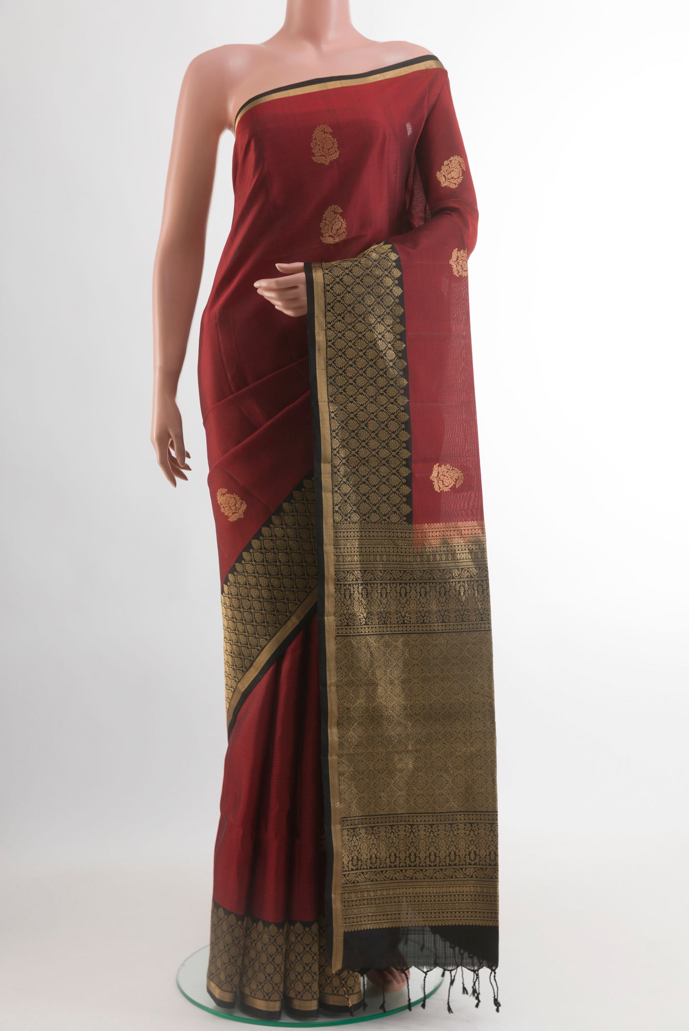 Maroon Soft Silk Saree with Zari Butta on the body and Zari Border.  displayed on a mannequin