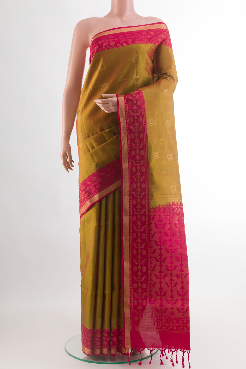 Green Soft Silk Saree with Zari Butta on the body and Zari Border.  displayed on a mannequin