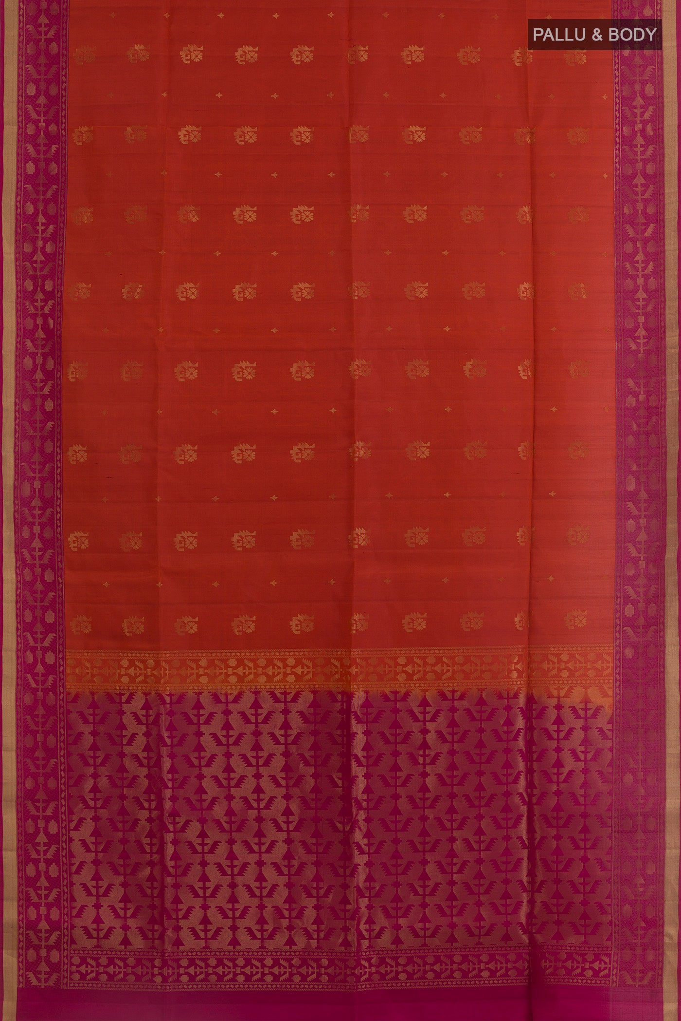 Flat view of Brick Orange Soft Silk Saree with Zari Butta on the body and Zari Border. 