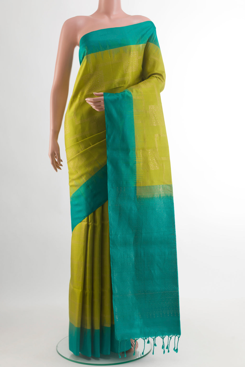 Green Soft Silk Saree with Zari Butta on the body and Zari Border.  displayed on a mannequin