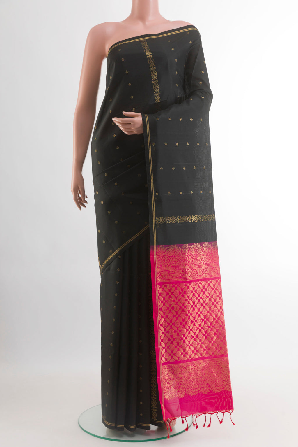 Black Soft Silk Saree with Zari Butta on the body and Zari Border.  displayed on a mannequin